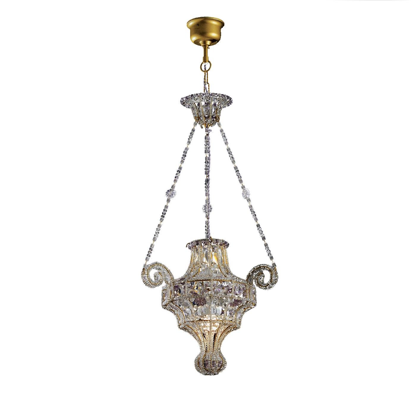 A masterful example of fine craftsmanship and elegant design, the chandelier will make a sophisticated statement in a classically furnished entryway or dining room in a traditional environment. Its structure was crafted of forged iron and adorned