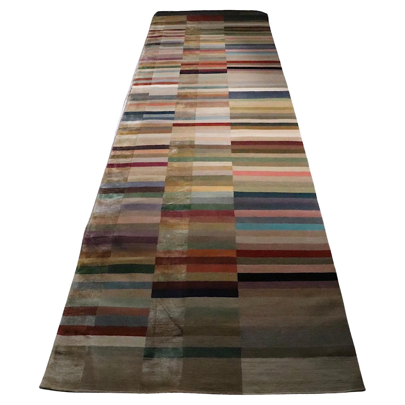 Incredible Spectrum pattern runner made in Nepal for The Rug Company. The carpet features three rows of  solid color blocks, who's warm rich tones exude voguish sophistication. The craftsmanship and quality of workmanship are also extraordinary, the
