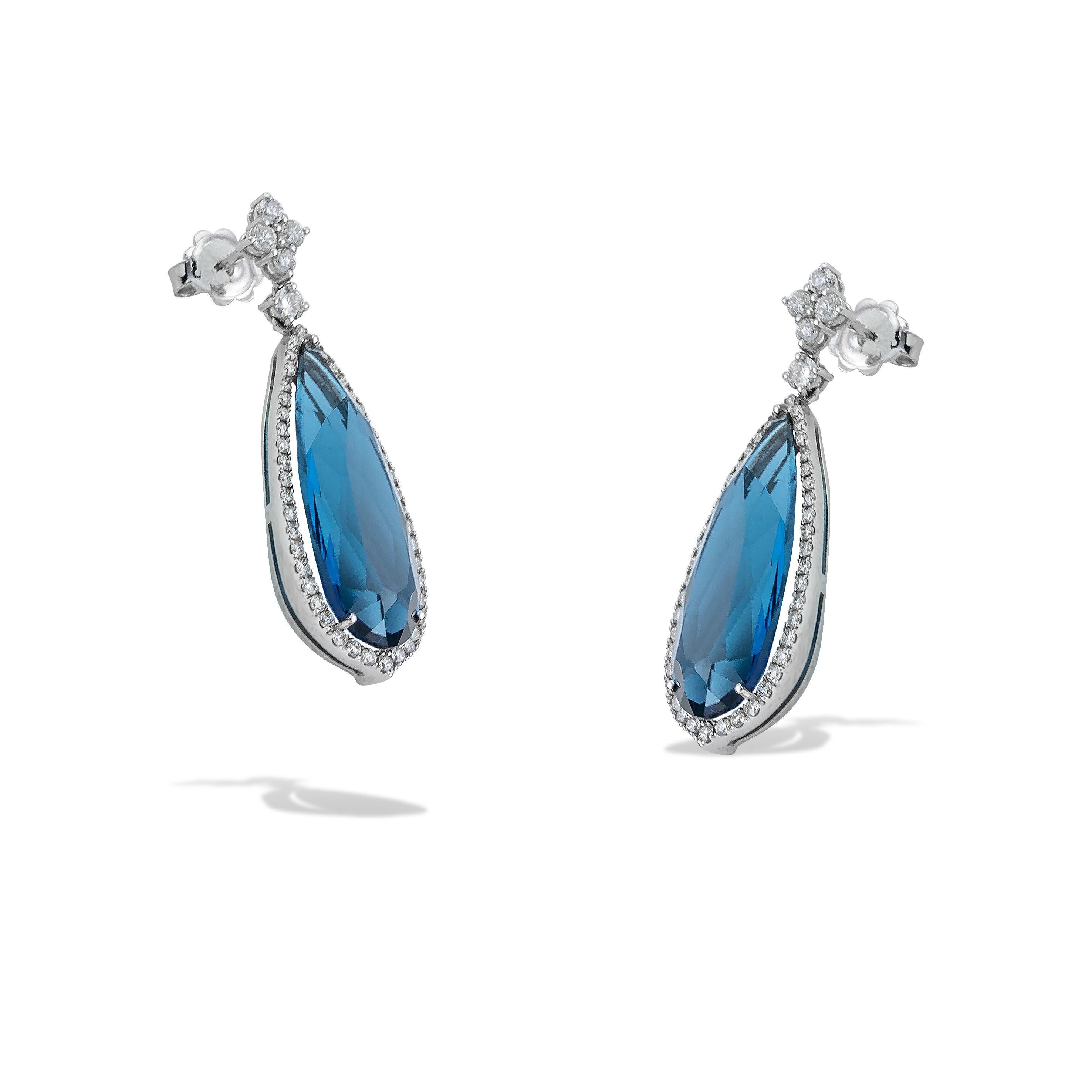 Unique long dangle earrings, Pear shape, with London Blue Topaz and white brilliant cut diamonds handcrafted in 18Kt white gold. The big and rare London Blue Topaz adds colour in your outfit while the brilliant diamonds around it play with the light