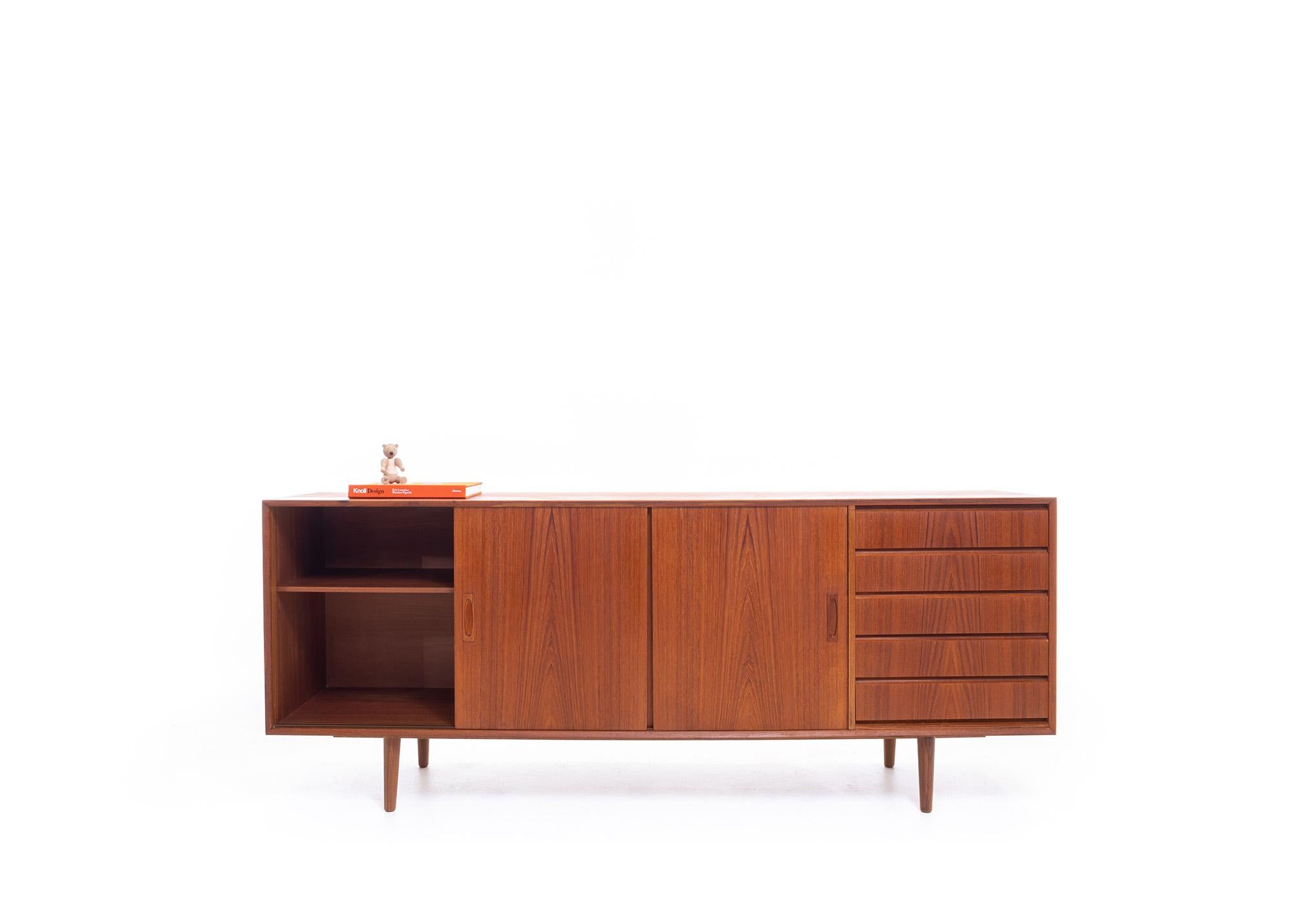 A beautiful Danish Mid-Century Modern Vintage Teak Sideboard with 6 Drawers and Interior Shelving. Crafted from high-quality teak, this sideboard boasts a Classic Mid-Century Modern design with clean lines and minimalistic hardware. It offers ample