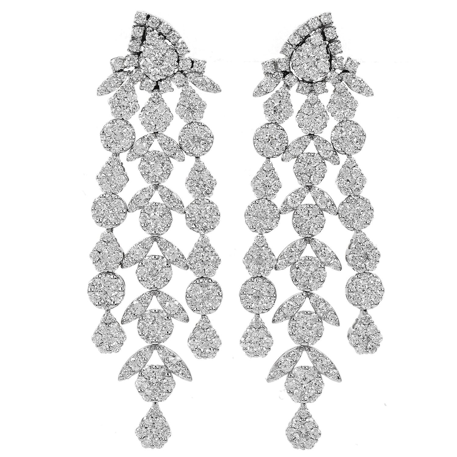 These Floral Link Dangle Drop Earrings are a remarkable pair of earrings that epitomize luxury.

They feature a dazzling display of diamonds set in 18K white gold, creating a captivating, elongated, and glamorous look.

The focal point of these