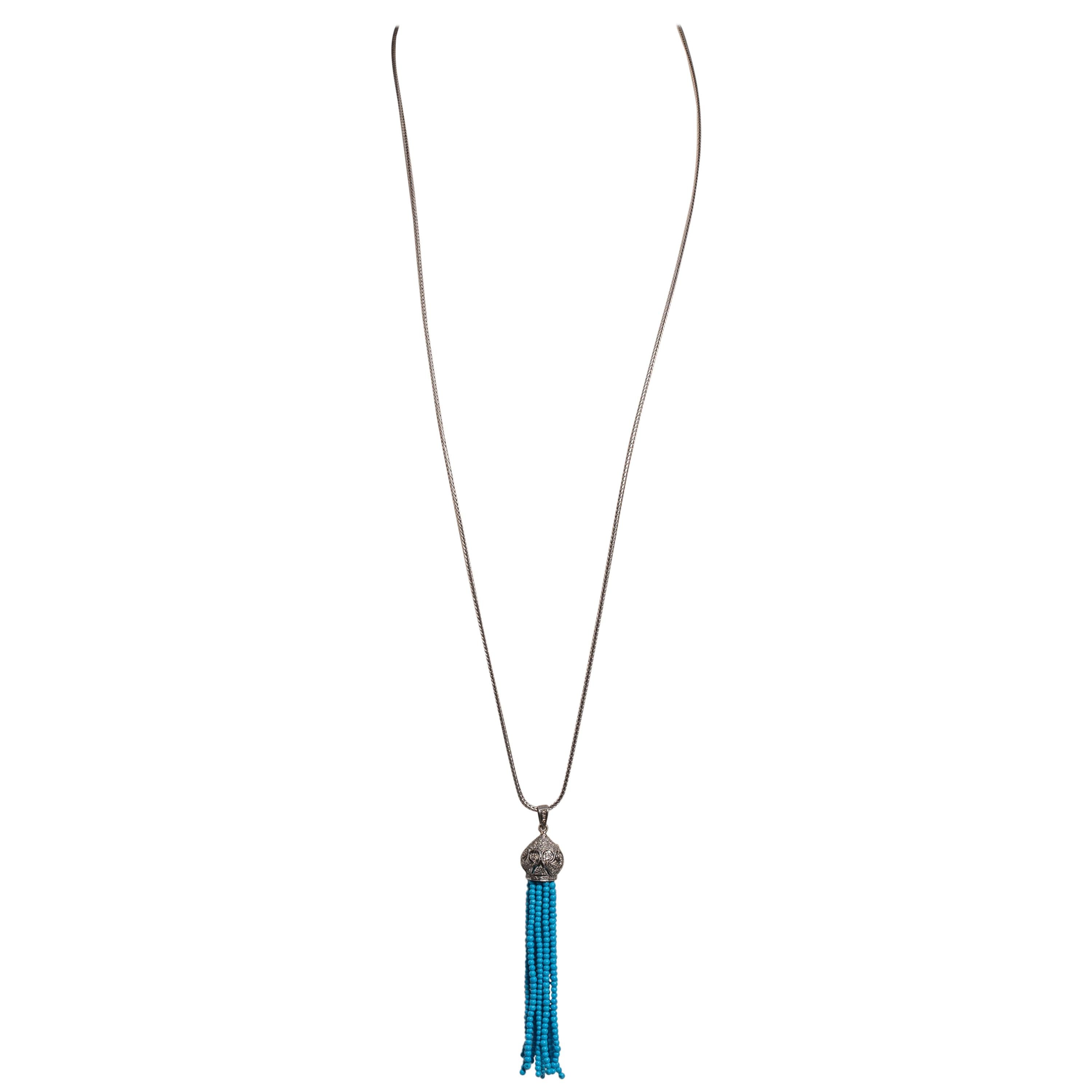A long, beaded turquoise and diamond tassel pendant on a long sterling silver hand-made chain.  Diamonds on the bail as well.  Diamonds are round, brilliant cut in a pave` setting. Just the chain is 36 inches long and could be doubled to allow for a