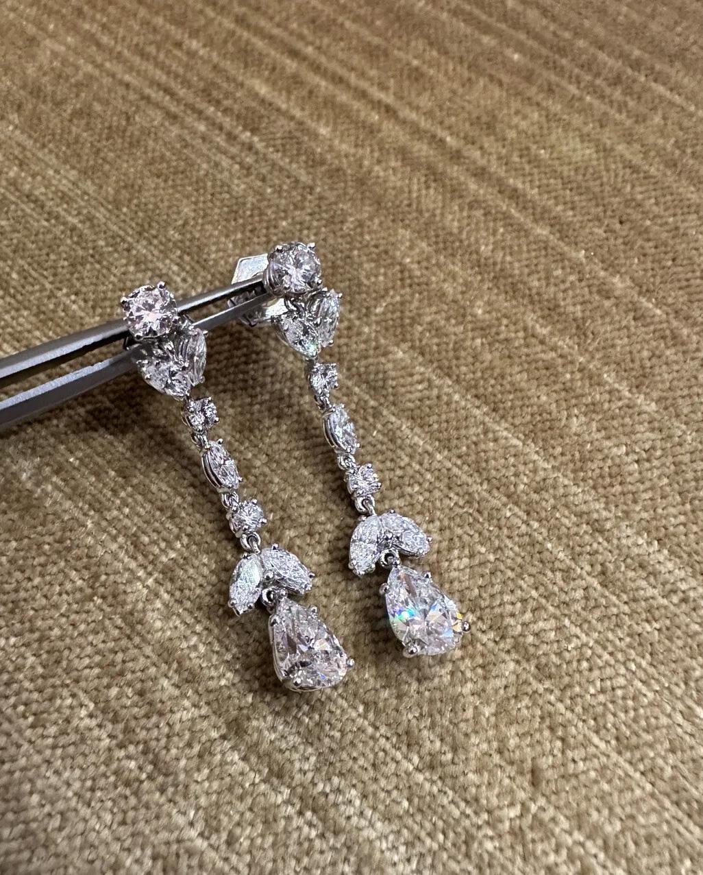 Long Diamond Drop Earrings with Pear Shapes in 18k White Gold and Platinum

Diamond Drop Earrings feature Round Brilliant, Marquise Brilliant, and Pear shape Diamonds set in 18k White Gold and Platinum. 

Large Pear Diamonds weigh .88 carats and .96