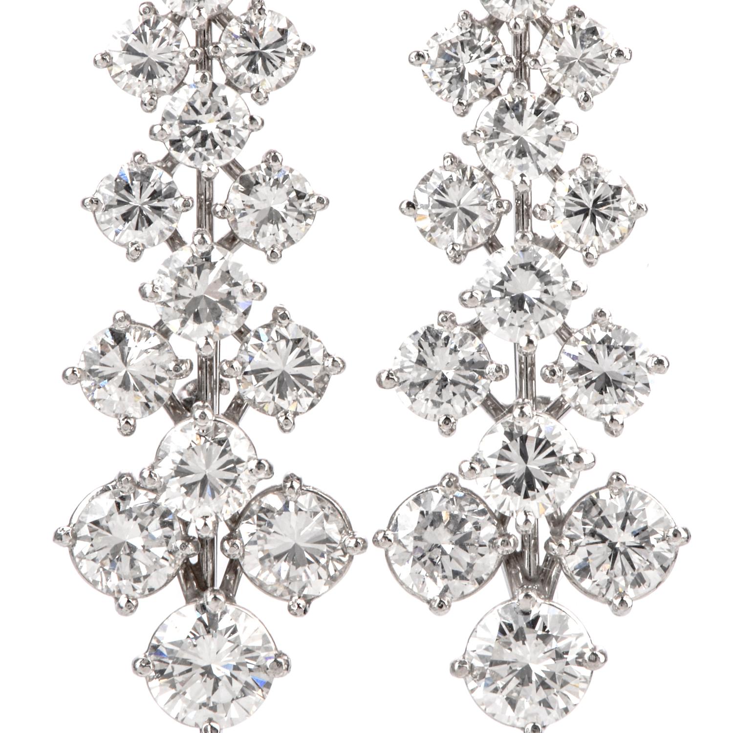 With every movement. This astonishing floral motif earrings have a small bud

at the top consisting of 5 marquise shaped diamonds.

Dangling from the flower are stems of diamonds in triplet patterns

repeating as teh diamonds are graduating in size
