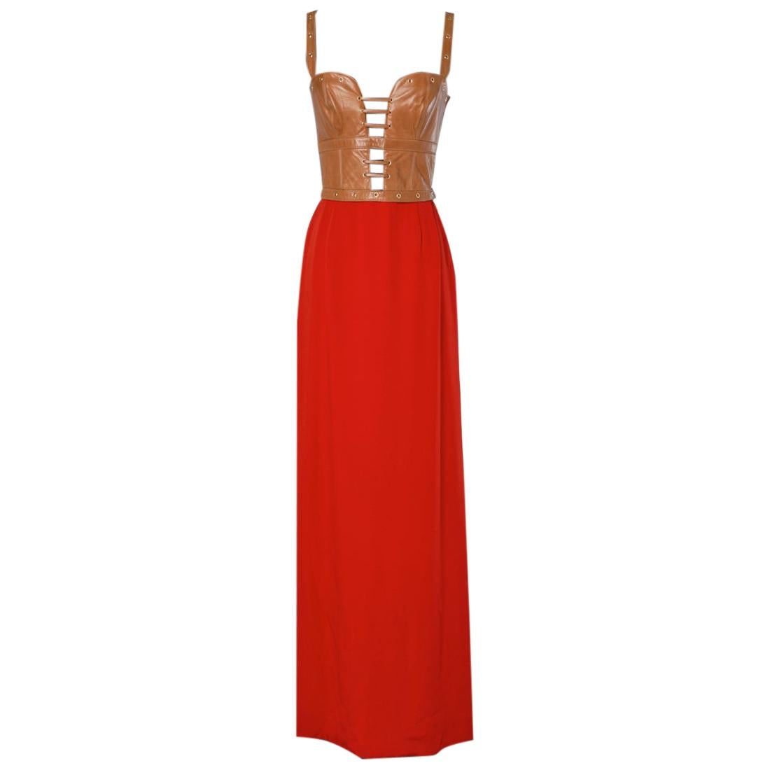 Long dress in corseted leather and red crepe with Genny label