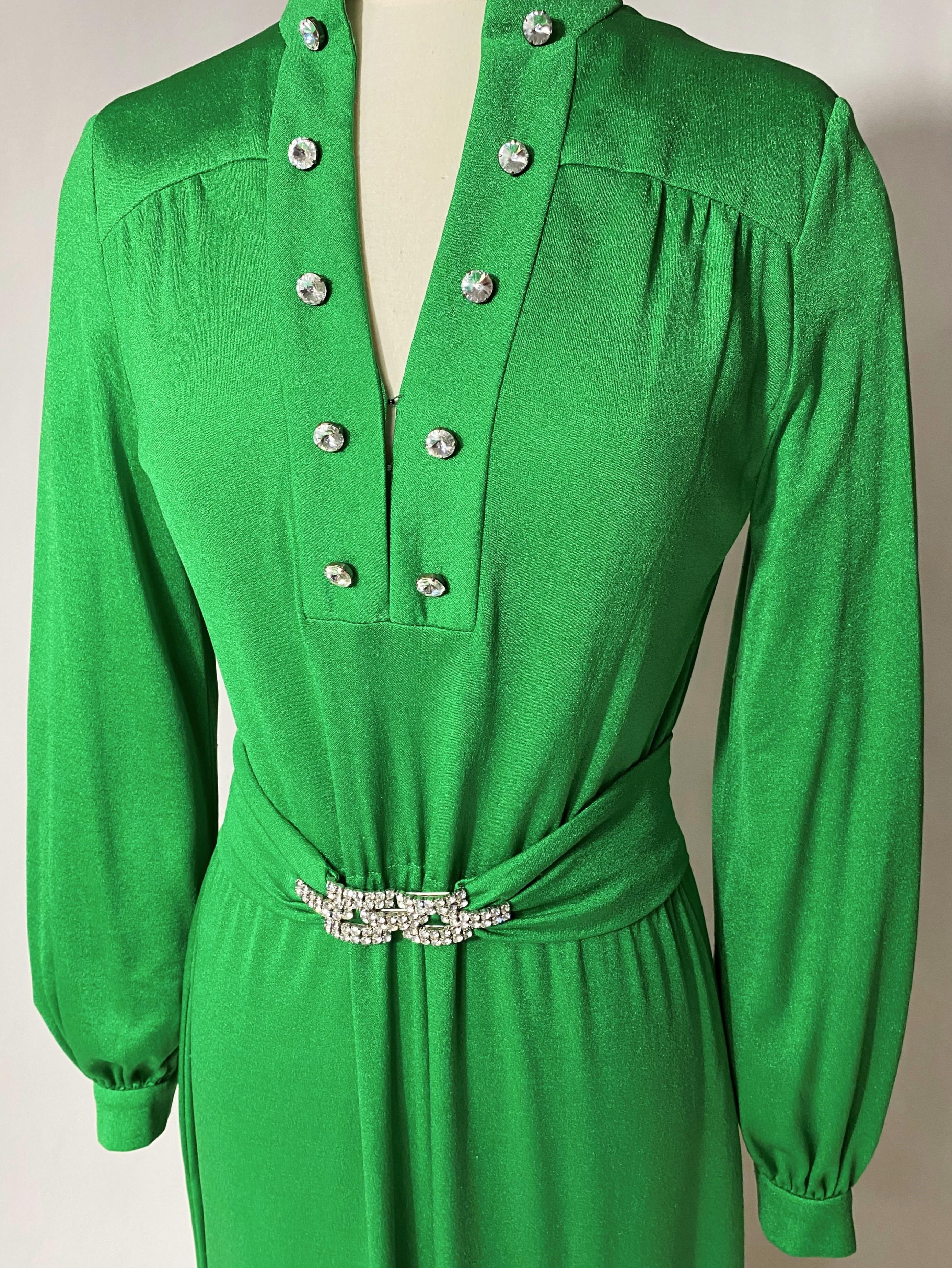 Circa 1970
Germany Berlin

Elegant flowing long dress in fir green stretch polyamide jersey by Berlin designer Uli Richter from the 1970s. The dress has long sleeves with slightly puffed cuffs and an elastic waistband. Crew neckline with split front