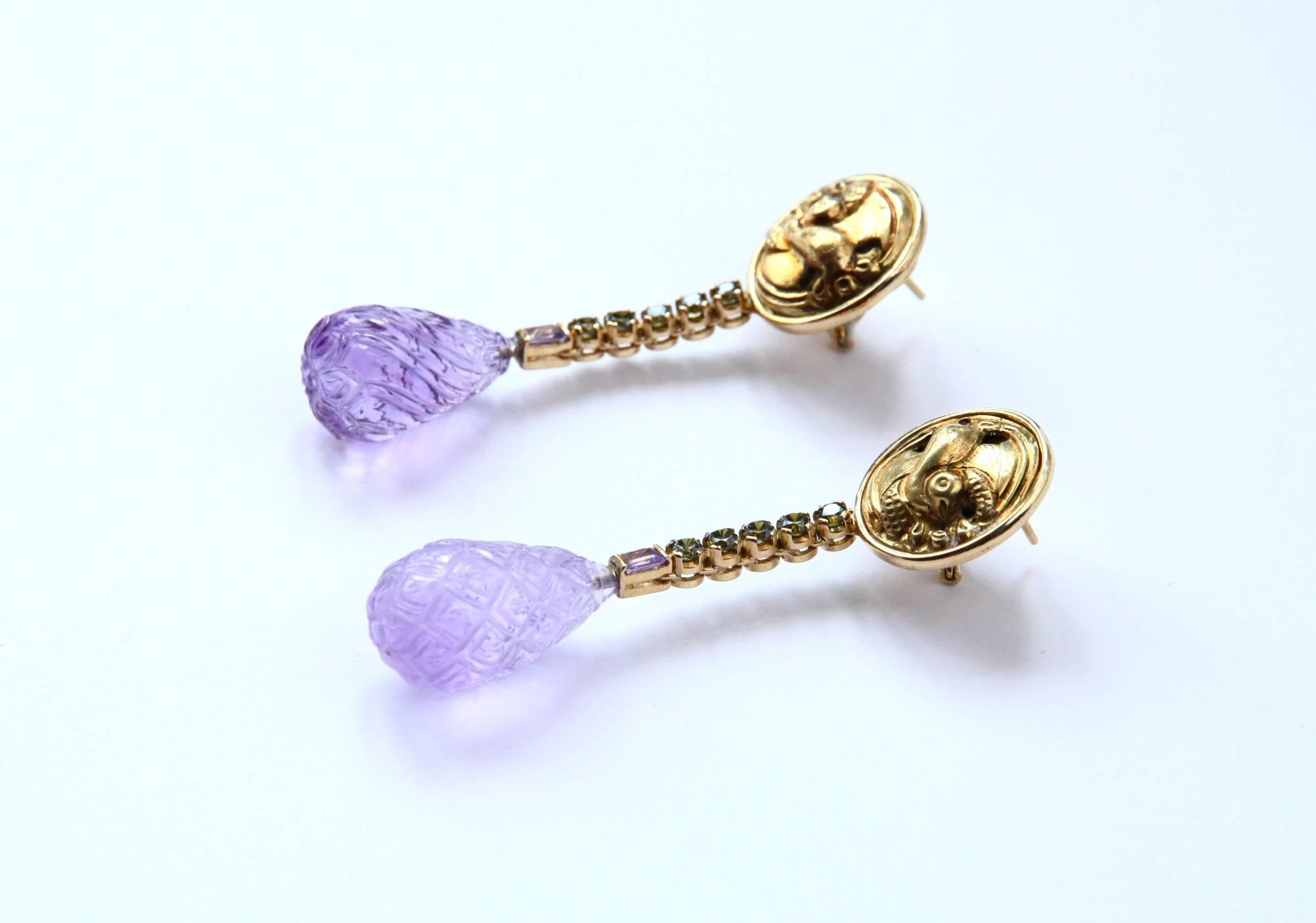 Those earrings are made with antiques Chinese baby button that representing little duck, then a  round peridot cts 0,40, again a rectangular amethyst and 2 amazing  amethyst drop with different engrave motif. 18kt gold gr. 15,00 total length