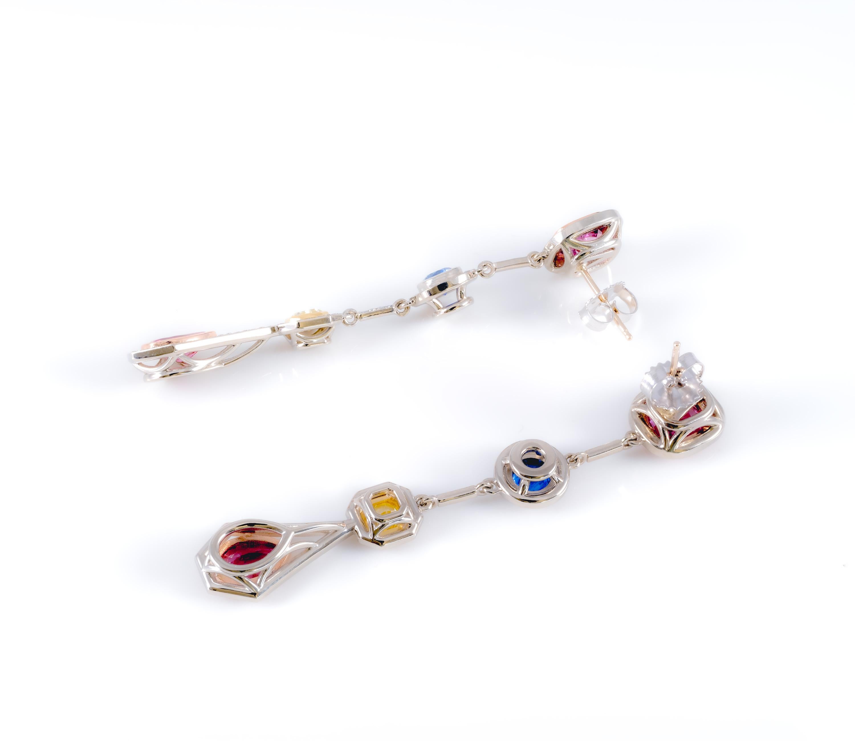These elegant long, flowing earrings have four segments with precious stones crowning each one of them: pink spinel, blue sapphire, yellow diamond, and pink tourmaline. These cocktail earrings feature outstanding artistry and are comfortable to wear