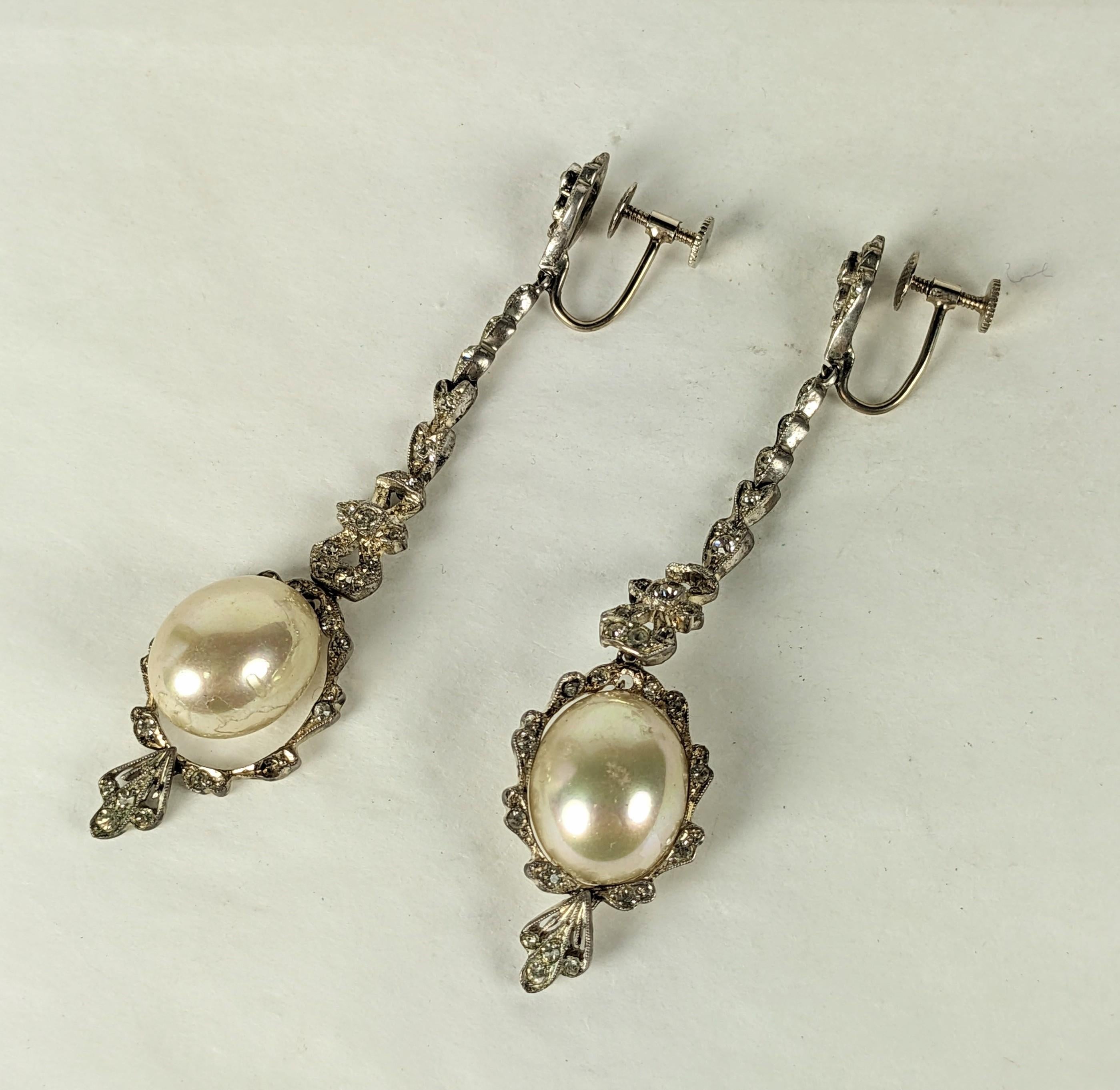 Lovely Delicate Edwardian Paste and Faux Pearl Earrings from the early 1900's. Tiny pastes set in articulated, hinged sterling with 14k white gold screw back fittings and glass pearl. 
High quality workmanship. USA 1900's. 3