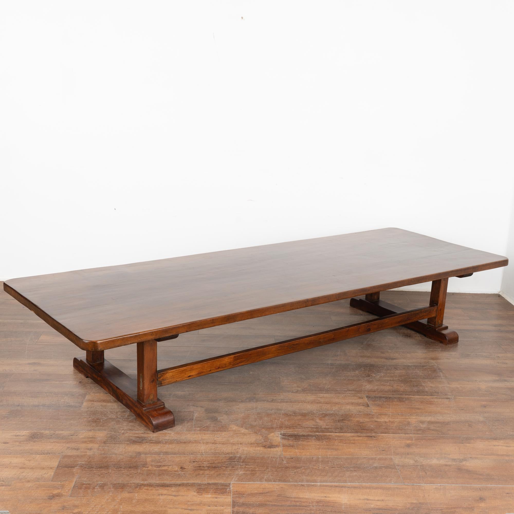 The beauty of this 9' long coffee table is found in the rich patina of the aged elm wood.
Every nick and stain add to the depth and richness found in the beauty of the top, resting on two long stretchers.
Restored, strong and stable. Any scratches,