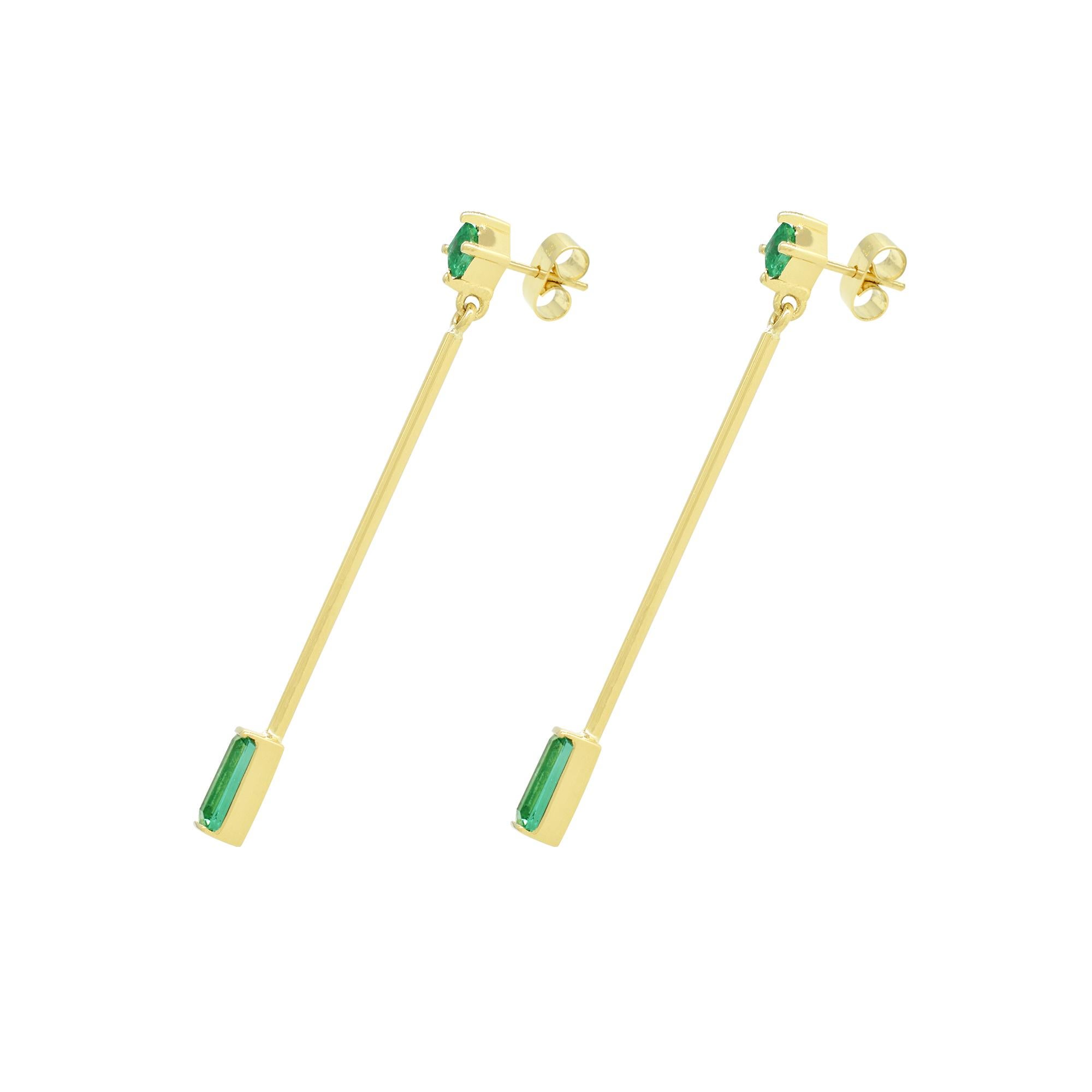 Emerald drop earrings in 18K yellow gold with emerald and baguette cut natural Colombian emeralds custom made in a thin, delicate and feminine dangle earrings design. A fantastic selection of 4 small emeralds with beautiful and vivid green color set