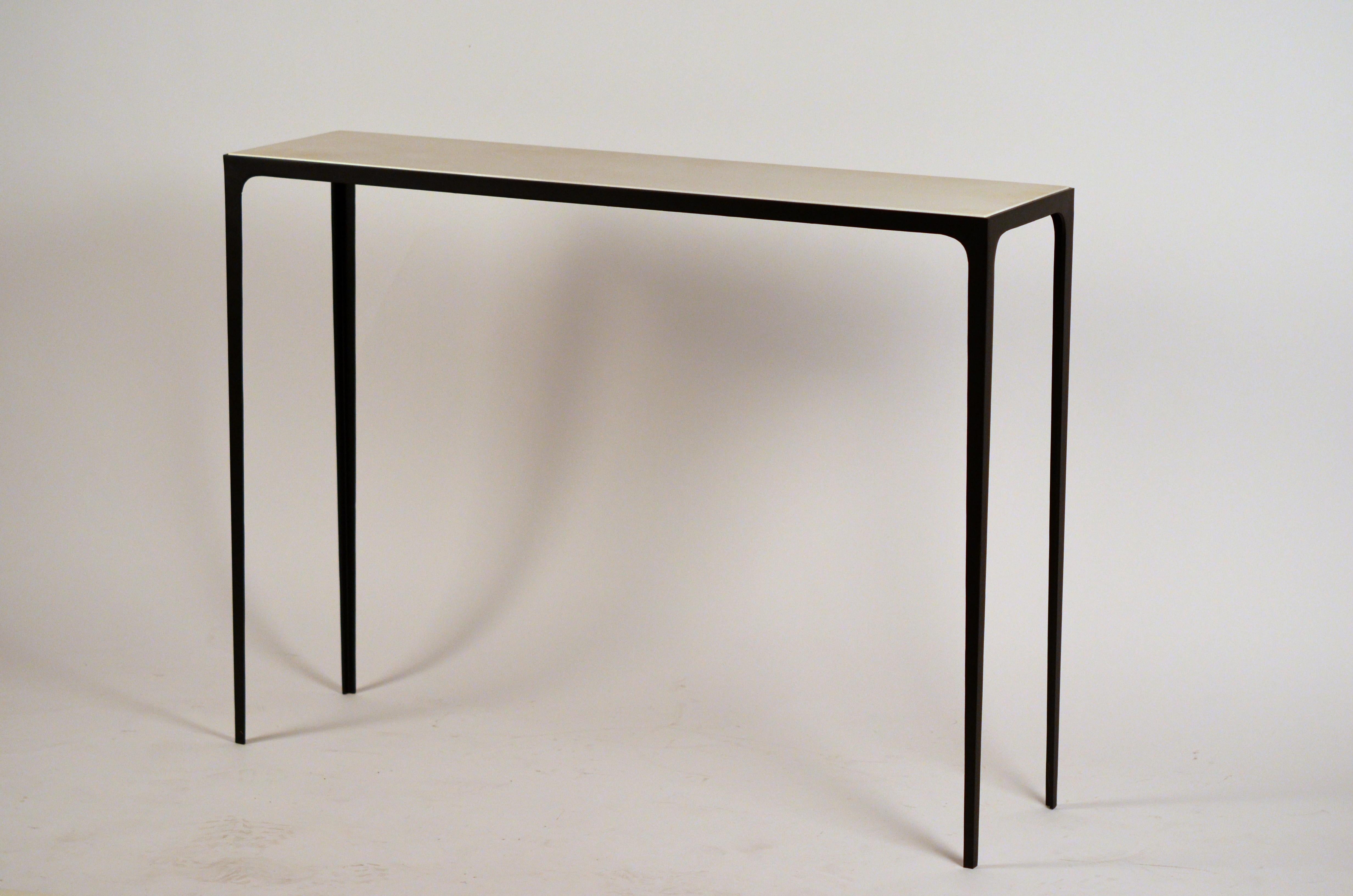 Long 'Esquisse' wrought iron and cream parchment console by Design Frères.

Chic handmade natural parchment top paired with a slender blackened wrought iron base.

Pair available.