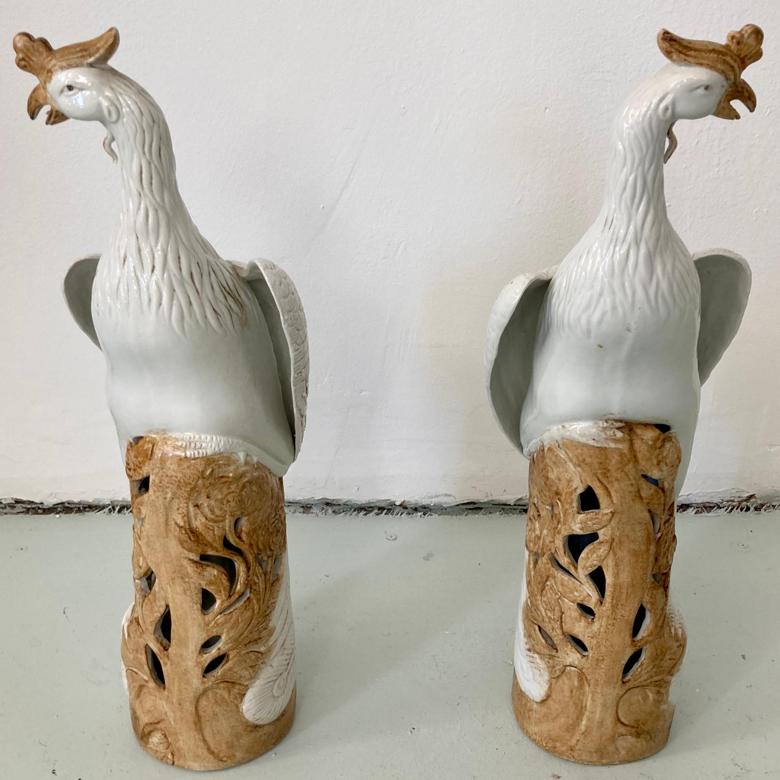 Beautiful pair of painted ceramic birds standing on a tall pedestal. Great addition to your boho chic inspired home. Would look great on any table top.