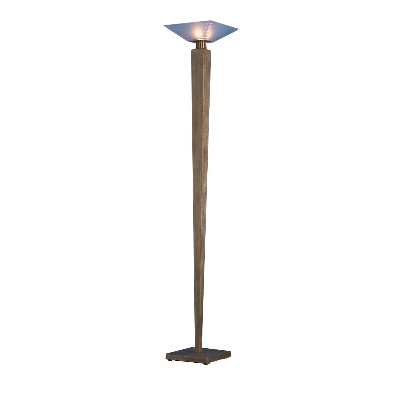 This magnificent floor lamp is a superb example of modern design and traditional craftsmanship. Its square base supports a long stem that tapered at the bottom towards the base. The hand forged iron structure has a striking, aged-gold finish that