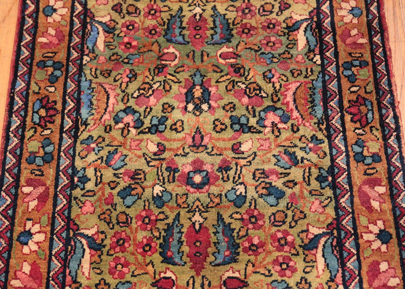 Antique Persian Kerman runner rug, country of origin: Persia, circa date: 1920. Size: 2 ft 2 in x 22 ft 6 in (0.66 m x 6.86 m)

The spectacular jewel tone colors of this impressive 22 foot long Kerman antique runner rug add a touch of decadence to a