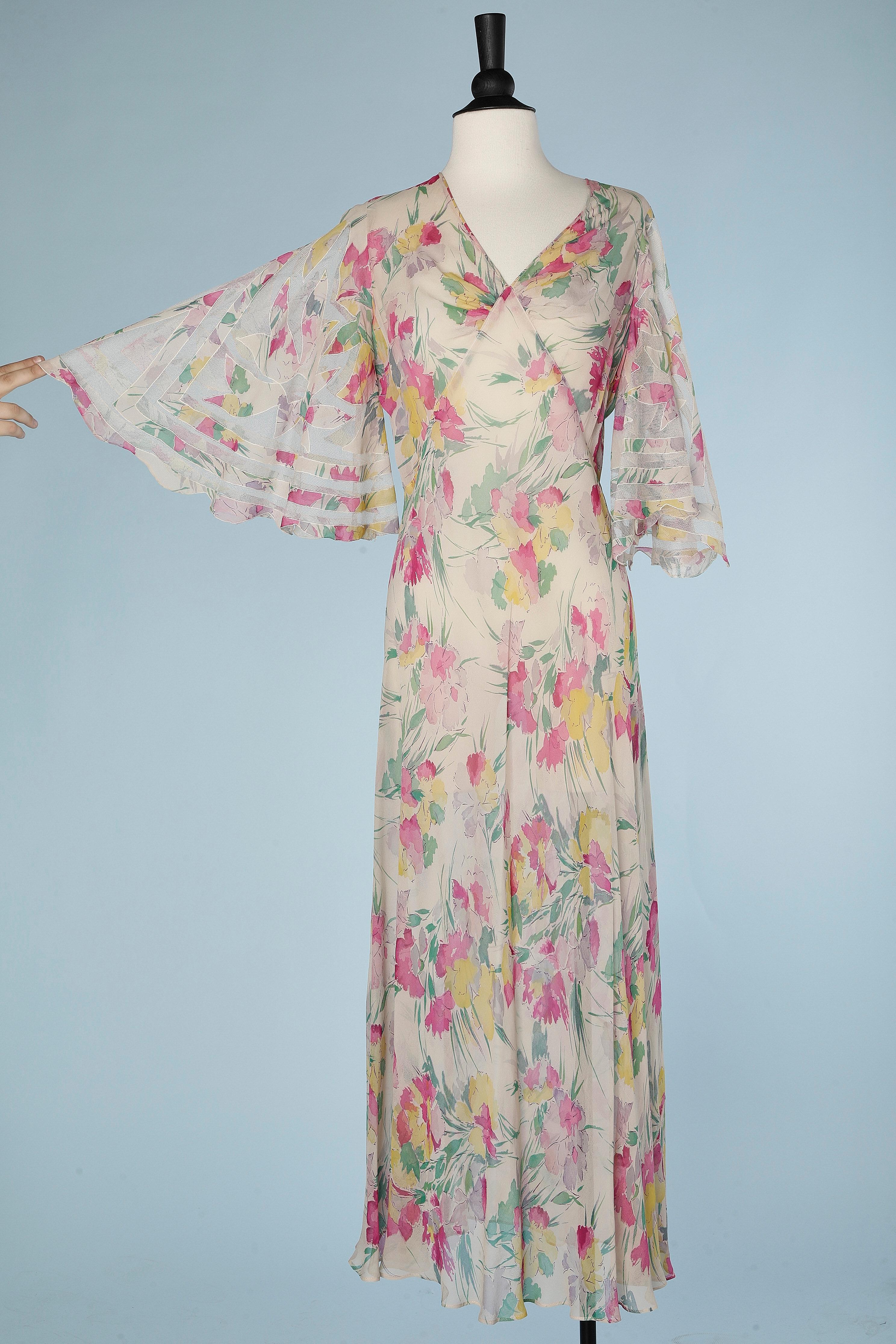 Long flower printed dress in chiffon with tulle appliqué on the sleeves. Biais. Cut-work. Draped on the bust. 
SIZE M