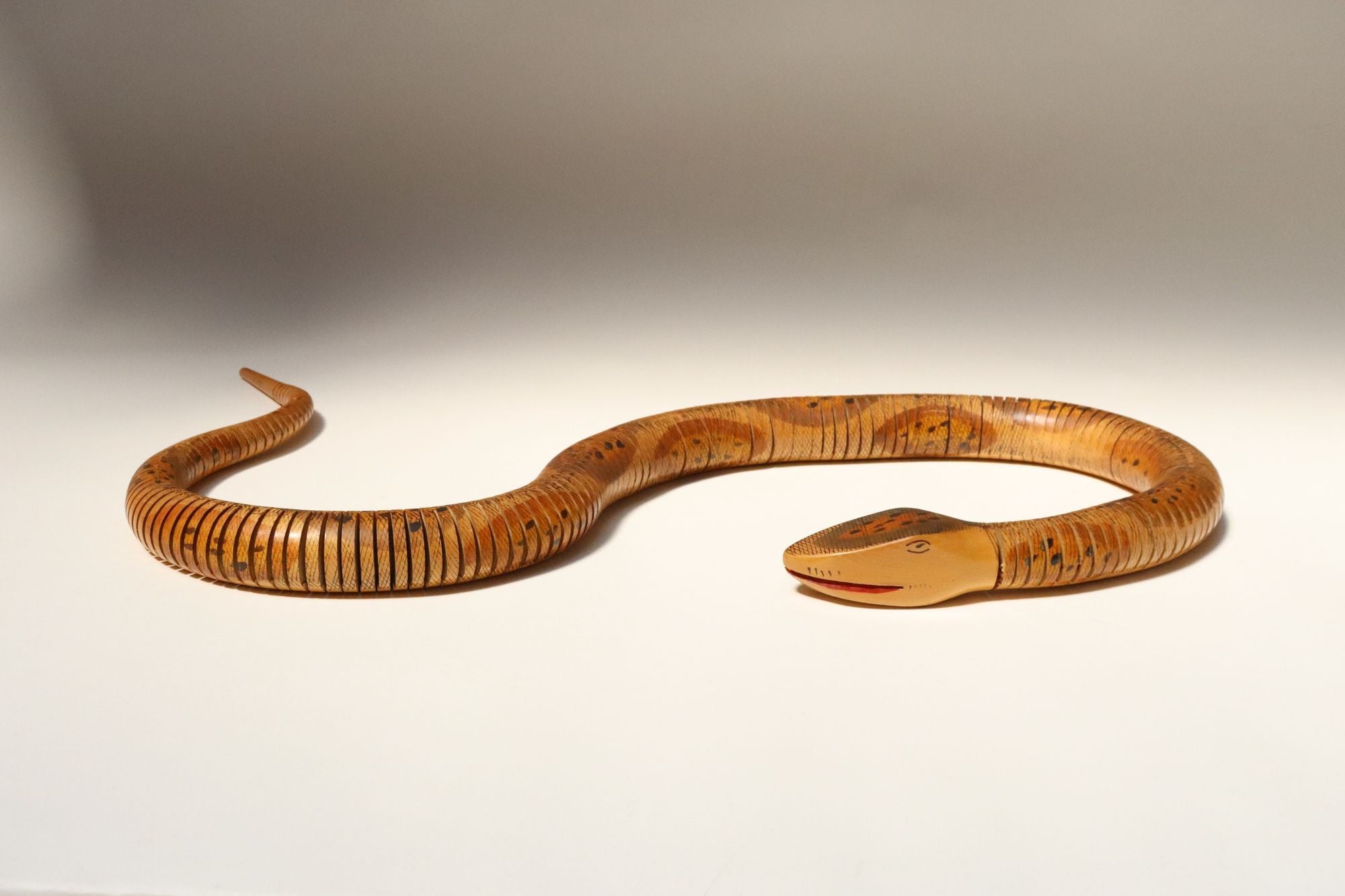 Long Folk Art Articulated Flexible Carved and Hand-Painted Snake Sculpture For Sale