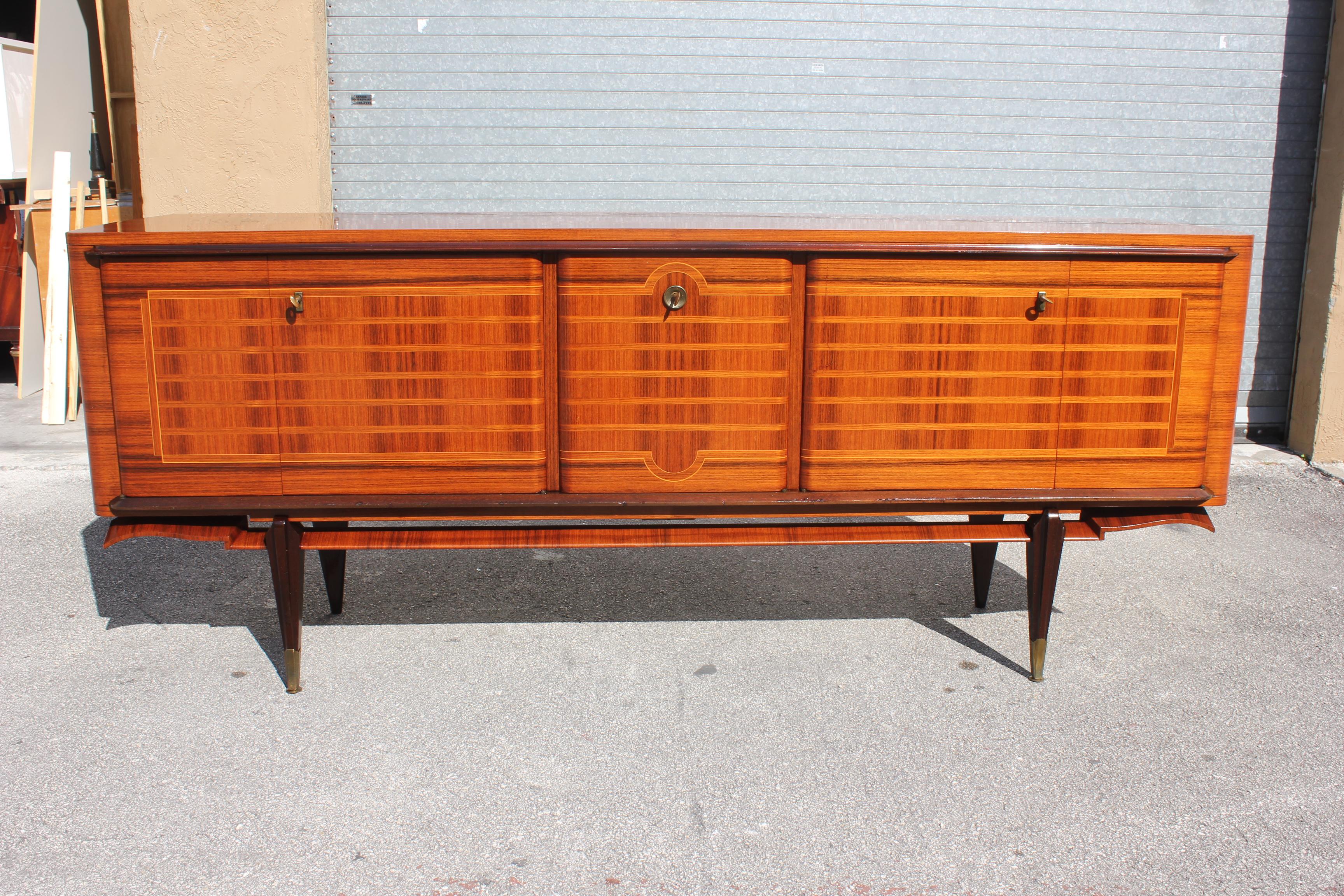 Beautiful French exotic Macassar ebony sideboard / buffet / bar, circa 1950s. The sideboard are in very good condition, with 2 drawers inside, and with 2 shelves adjustable, and bar section ,you can remove all the shelves if you need more Space