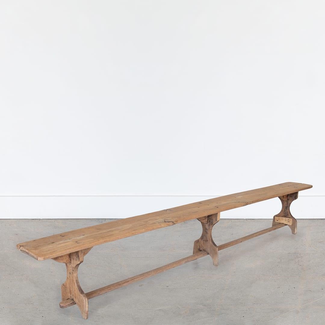 Incredible extra long oak wood bench from France, 1920's - nearly 10' in length. Beautiful details and trestle legs. Original light wood finish showing nice age and patina. 