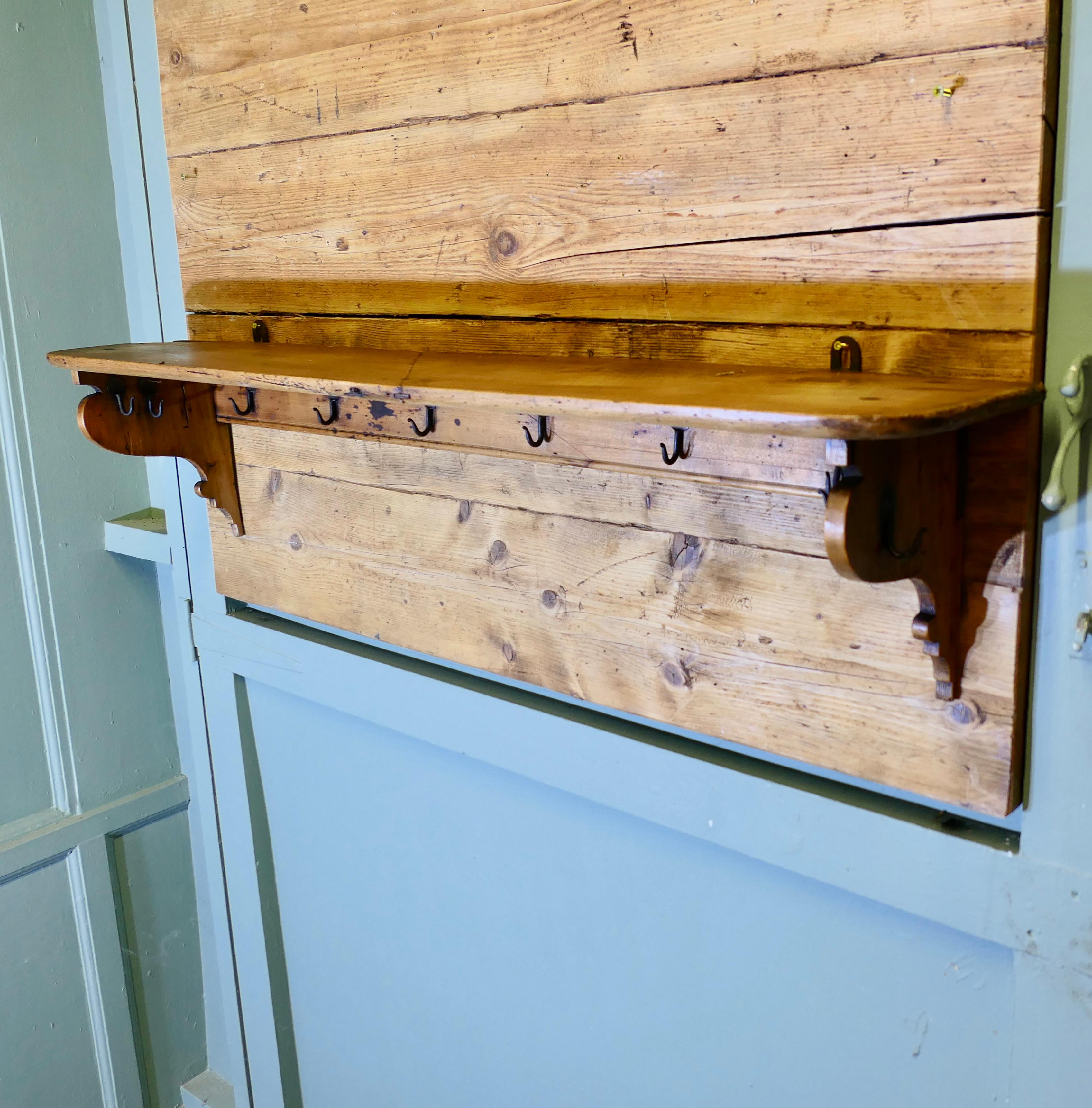 Long French Pine Wall Shelf, with Blacksmith made Hooks

This long rustic pine Farmhouse shelf has shaped side supports at each end, under the shelf there are 10 iron Blacksmith made hooks, the shelf has many uses either as a kitchen shelf and pot