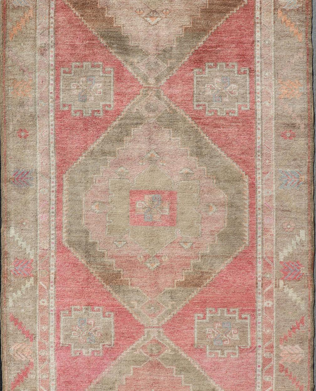 Vintage wide and long gallery runner from Turkey with geometric Medallion design in various tones of pink, coral, tan and variety of beautiful green colors, rug EN-179586, country of origin / type: Turkey / Kars, circa 1940

This beautiful vintage