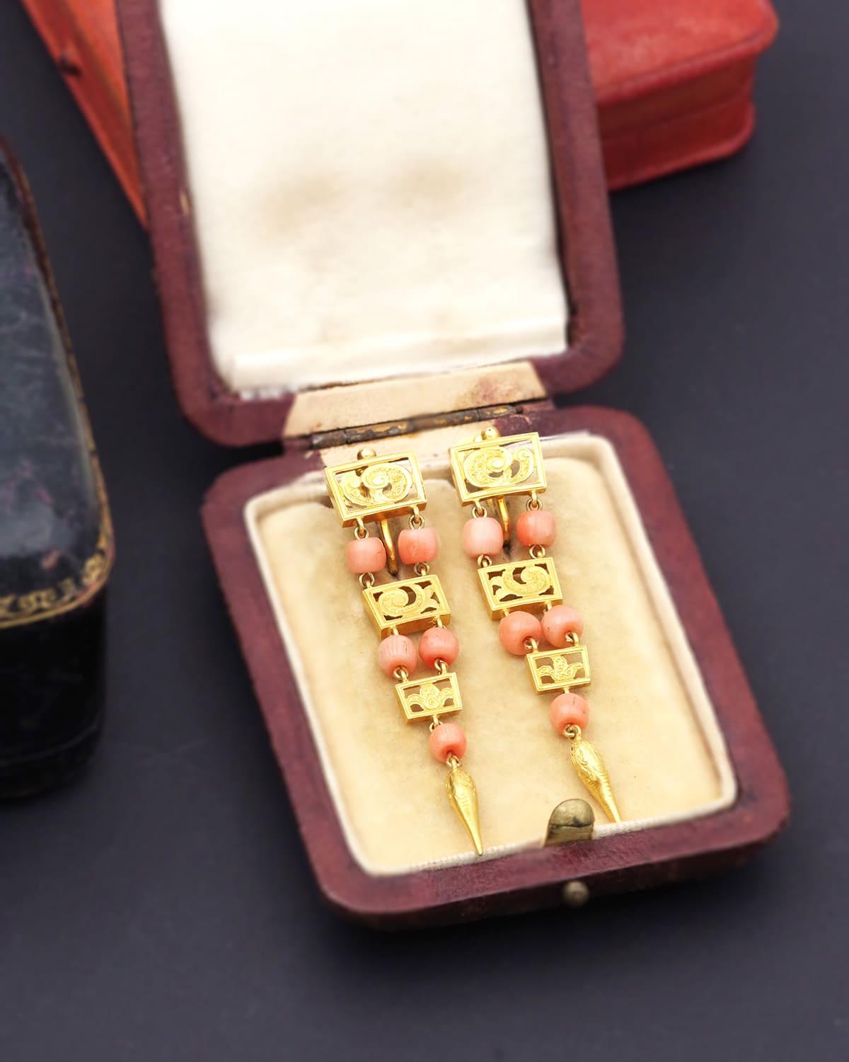 Long Georgian Italian earrings and 18 karat gold drop earrings. These large, hinged earrings are for non-pierced ears. They consist of three tiers formed by rectangular plates decorated with scrolls. Coral beads, a beautiful pinkish-orange hue,