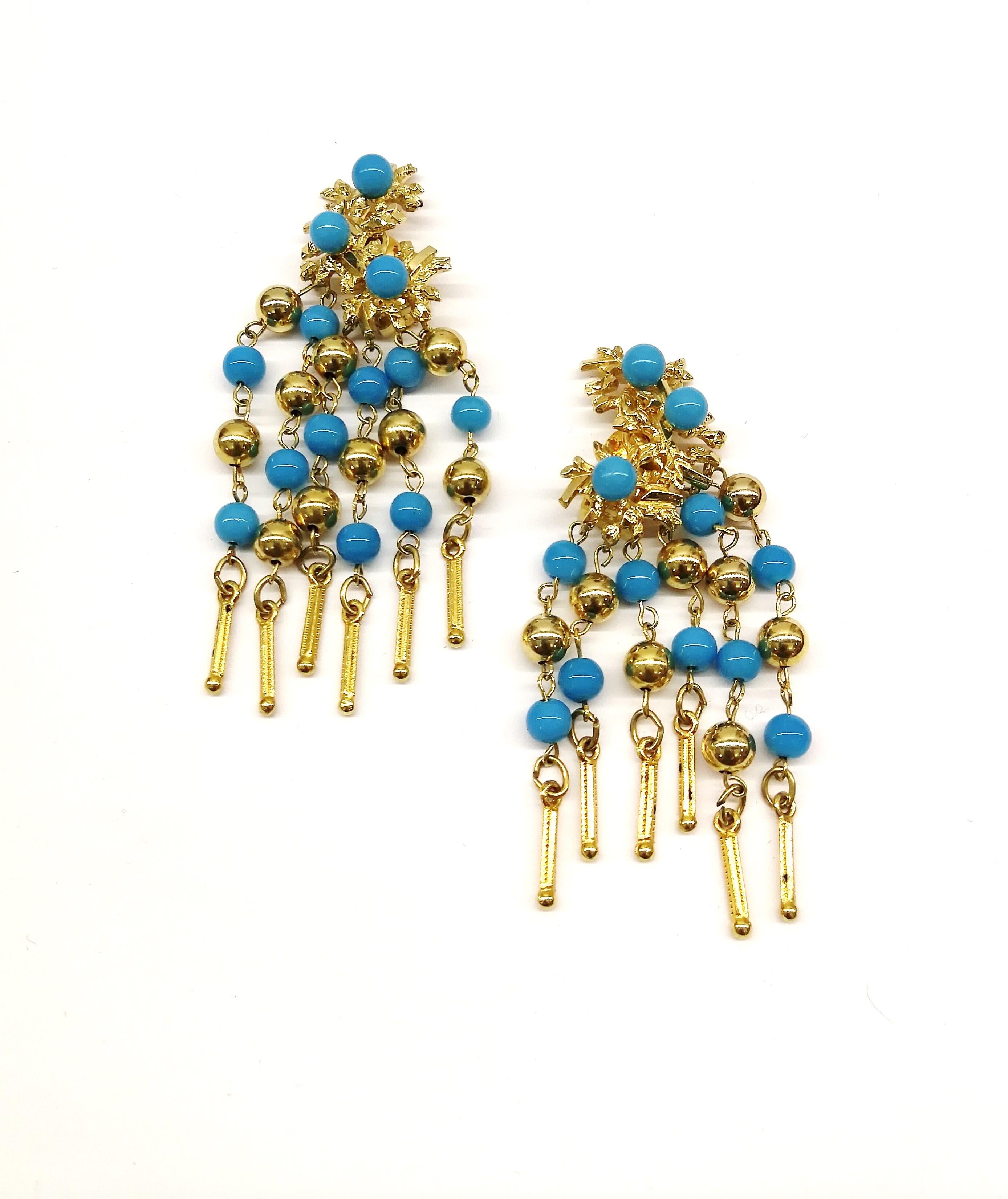 These fringed drop earrings from Christian Dior are a Summery and stylish addition to any wardrobe. With a design of abstracted gilt floral motifs on the top half of the earrings, set with round turquoise glass beads, the bottom half drops down in
