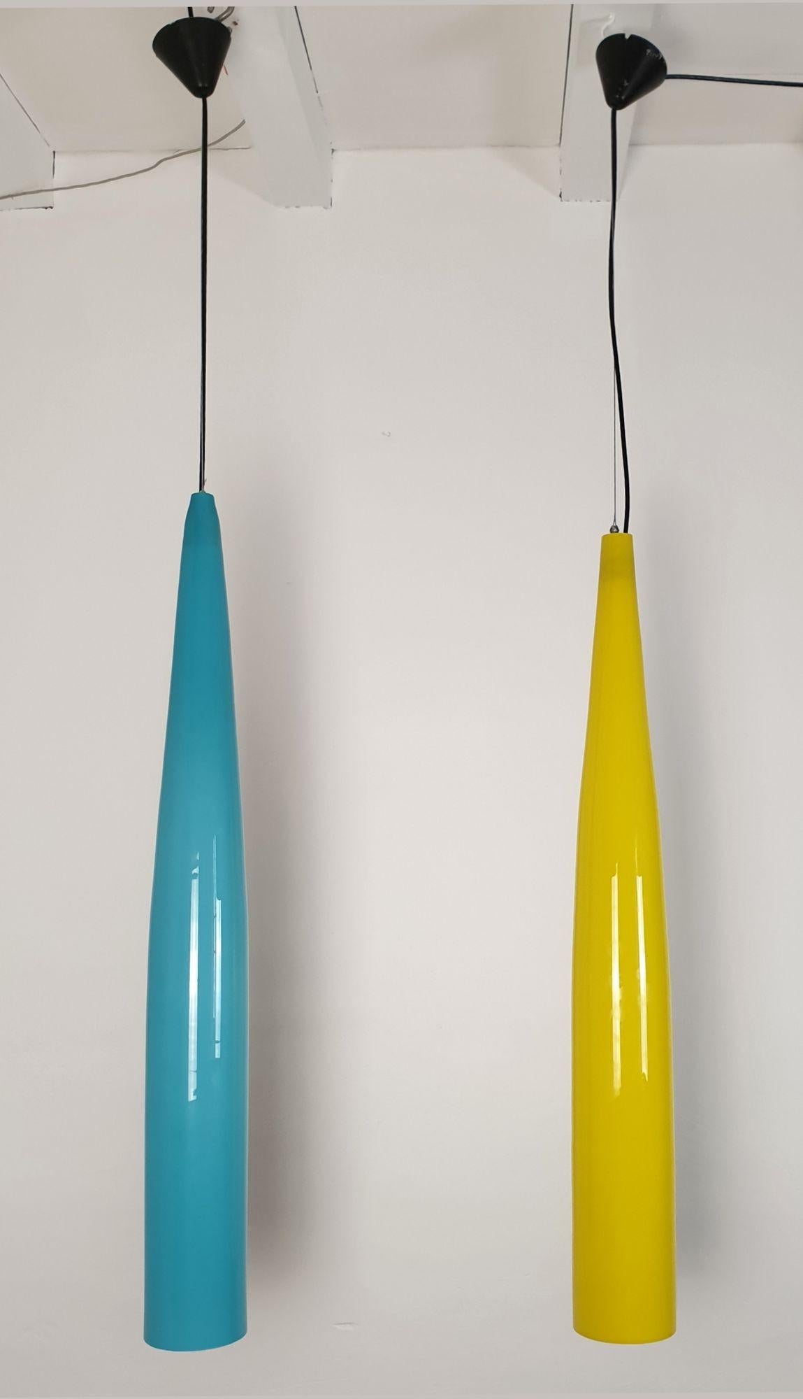 Very long Mid-Century Modern Murano glass pendant lights, by Alessandro Pianon for Vistosi, Italy 1960s.
The pair is made of a sky blue and a yellow Murano glass pendants.
The double layered glass (white on the inside the blue one) (yellow in the