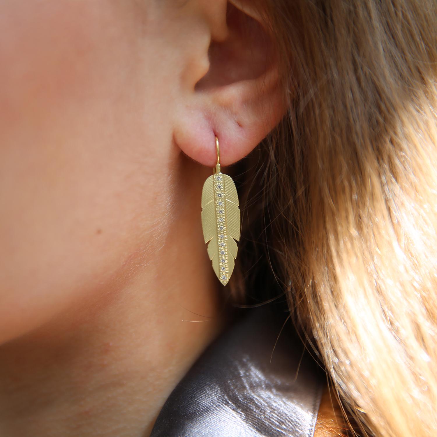 These earrings are truly a statement! Glowing 18k yellow gold plumes are pave set with a vertical channel of white diamonds and topped with tube set white diamonds. The perfect accessory for a night out on the town!! Earrings measure from ear 1