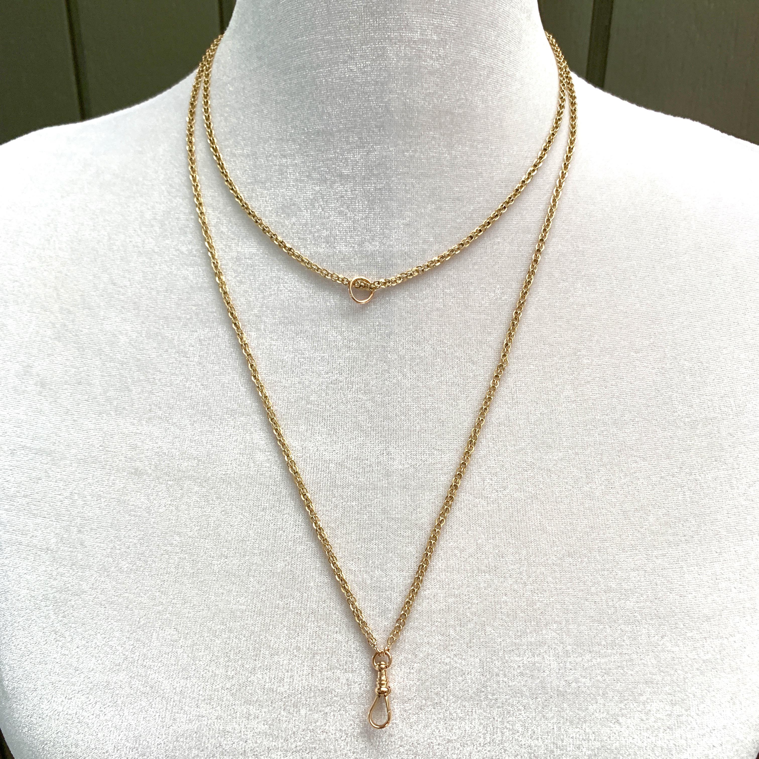 While not particularly thin, the airiness of the open cage links and the size of the swivel clip on this long guard chain lead us to believe it was originally a lady's chain.  

A fine quality gold chain in this length was as versatile 100+ years