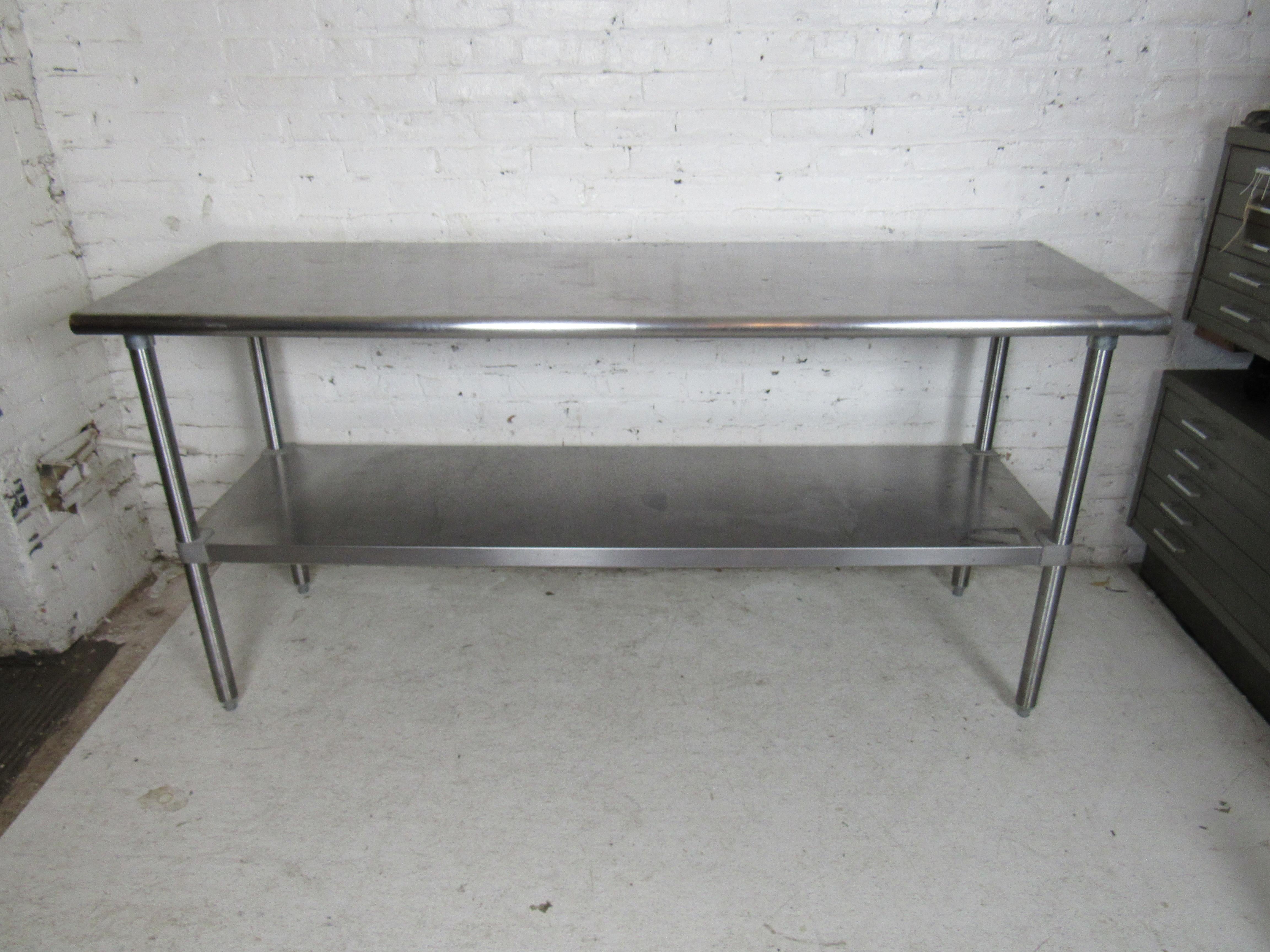 Long vintage metal kitchen table featuring two tiers, would make a great kitchen island or dining table.

(Please confirm item location - NY or NJ - with dealer).