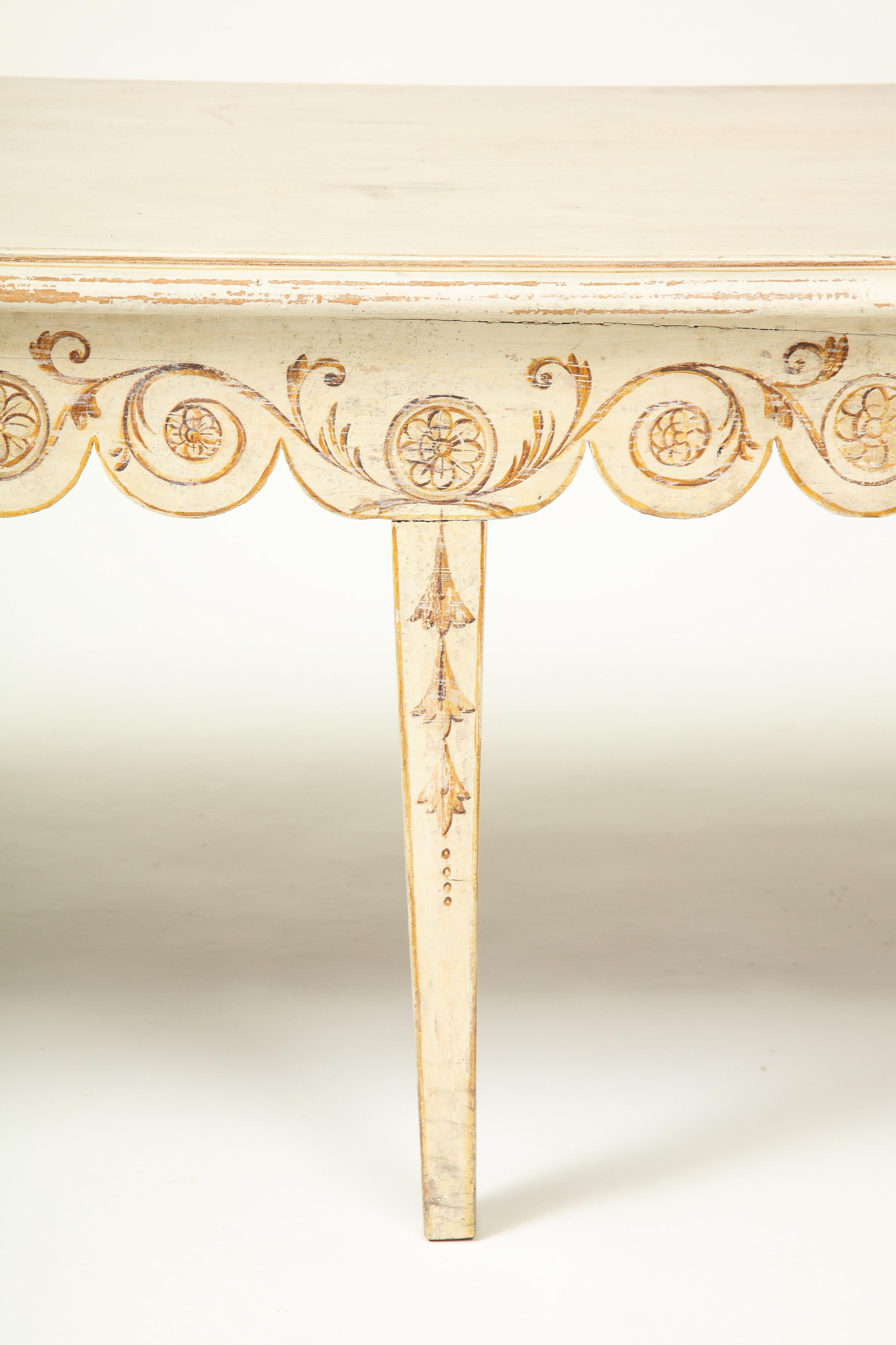 Attributed to Colefax & Fowler. The rectangular seat over a scalloped seat rail painted in ochre with scrolling foliage and flowerhead roundels; raised on square tapering legs with bellflower garland decoration.

Provenance: From the Collection of