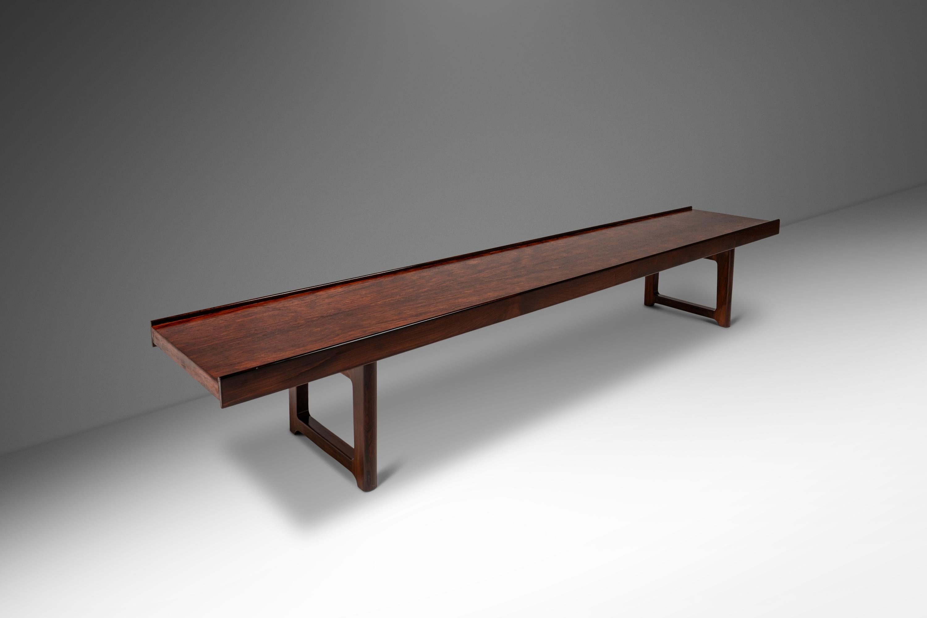 Introducing a rare, fully restored long “Krobo” bench designed by the influential Torbjørn Afdal for Bruksbo. Constructed from a mix of solid and veneered Brazilian rosewood with stunning variegated woodgrains unique to the species this bench