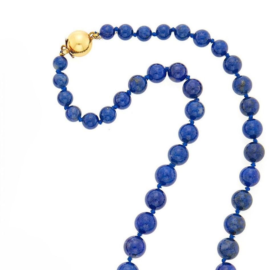 This necklace delicately features 51 lapis, medium blue beads, clasped together with a 14K yellow gold closure.
