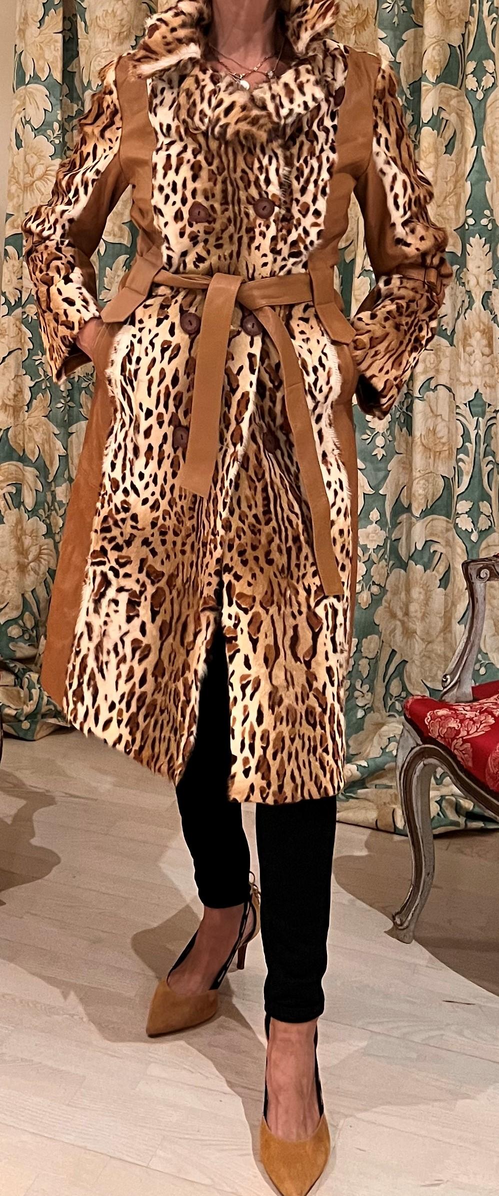 Long Leopard and brown Leather Coat Fur (Outer), 100% Silk (Lining)
Rain Coat Style
The coat has 2 pockets and belt and four buttons 
Size: 40- 42 Europe - 8- 10 US 
2 Large pockets with a small slot pocket inside.
Simplicity at its timeless