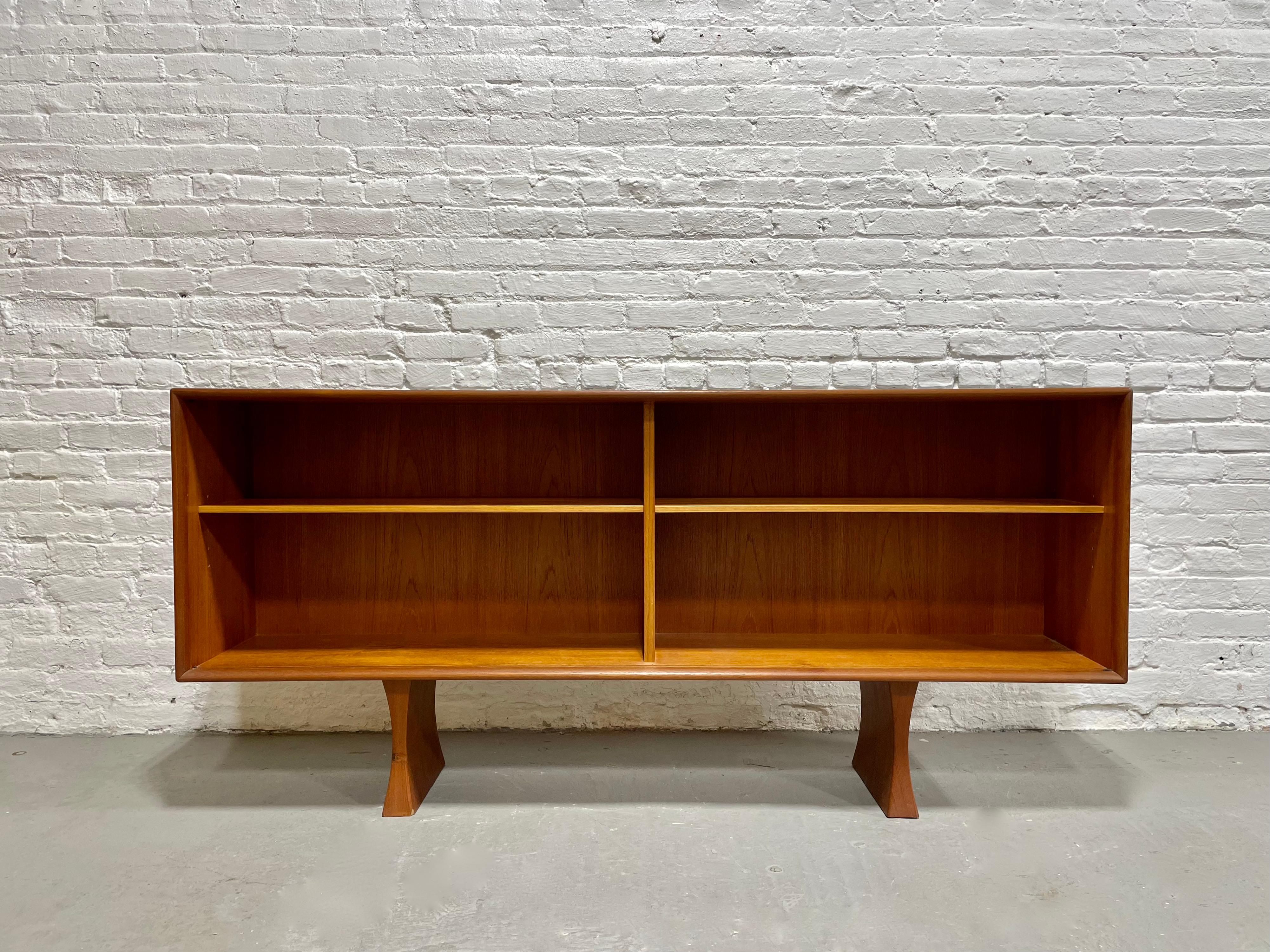 Mid Century Teak Danish Bookcase / credenza - Made in Denmark by Bernhard Pedersen. Plenty of room for books or displaying your collection; shelves are removable and adjustable. The wood grains are rich and stunning as well. Slat teak legs are solid