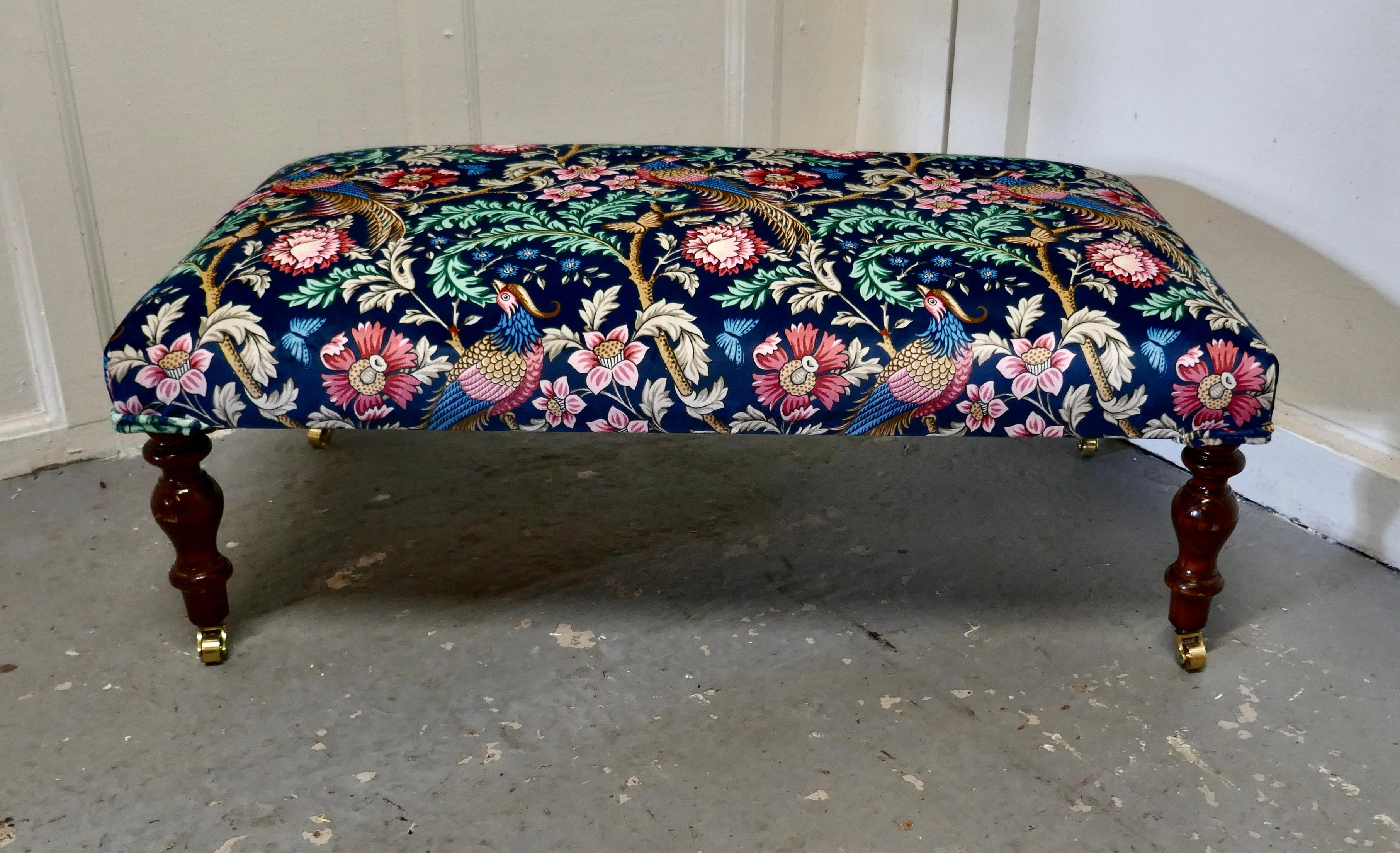 Long low stool upholstered in navy liberty William Morris Velvet

This is a charming stool it has turned mahogany legs set on brass casters 
The stool has new upholstery it has been covered with Liberty Blue Oakmere Velvet, a superb soft fabric