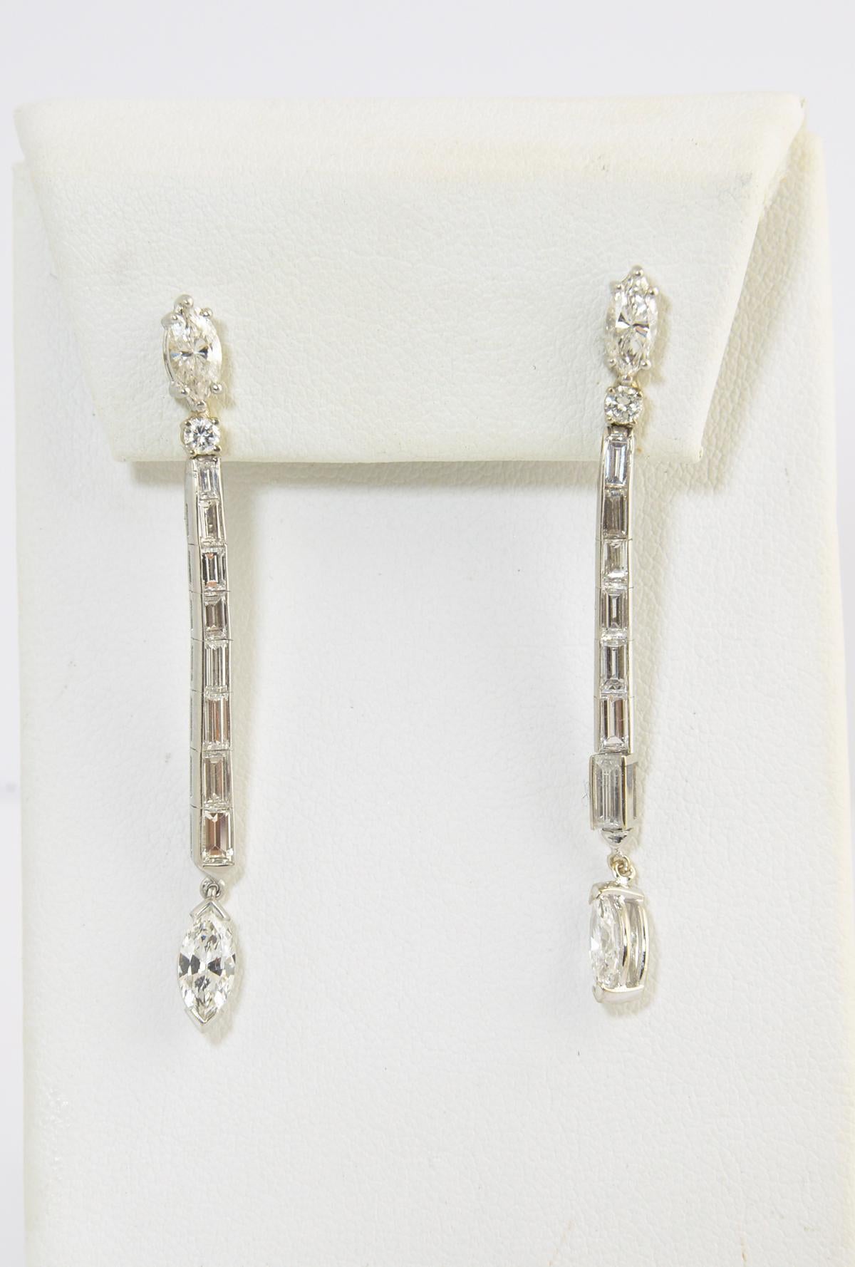 Long dangle diamond pierce post back earrings. The top and middle section are platinum.  The mount for the bottom stones and the backs are 14K white gold. Diamonds, approximately 4.2 carat total weight; top two diamonds, 1 carat total; bottom two