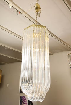Long Mid-Century Curved Lucite Ribbon Chandelier in Brass