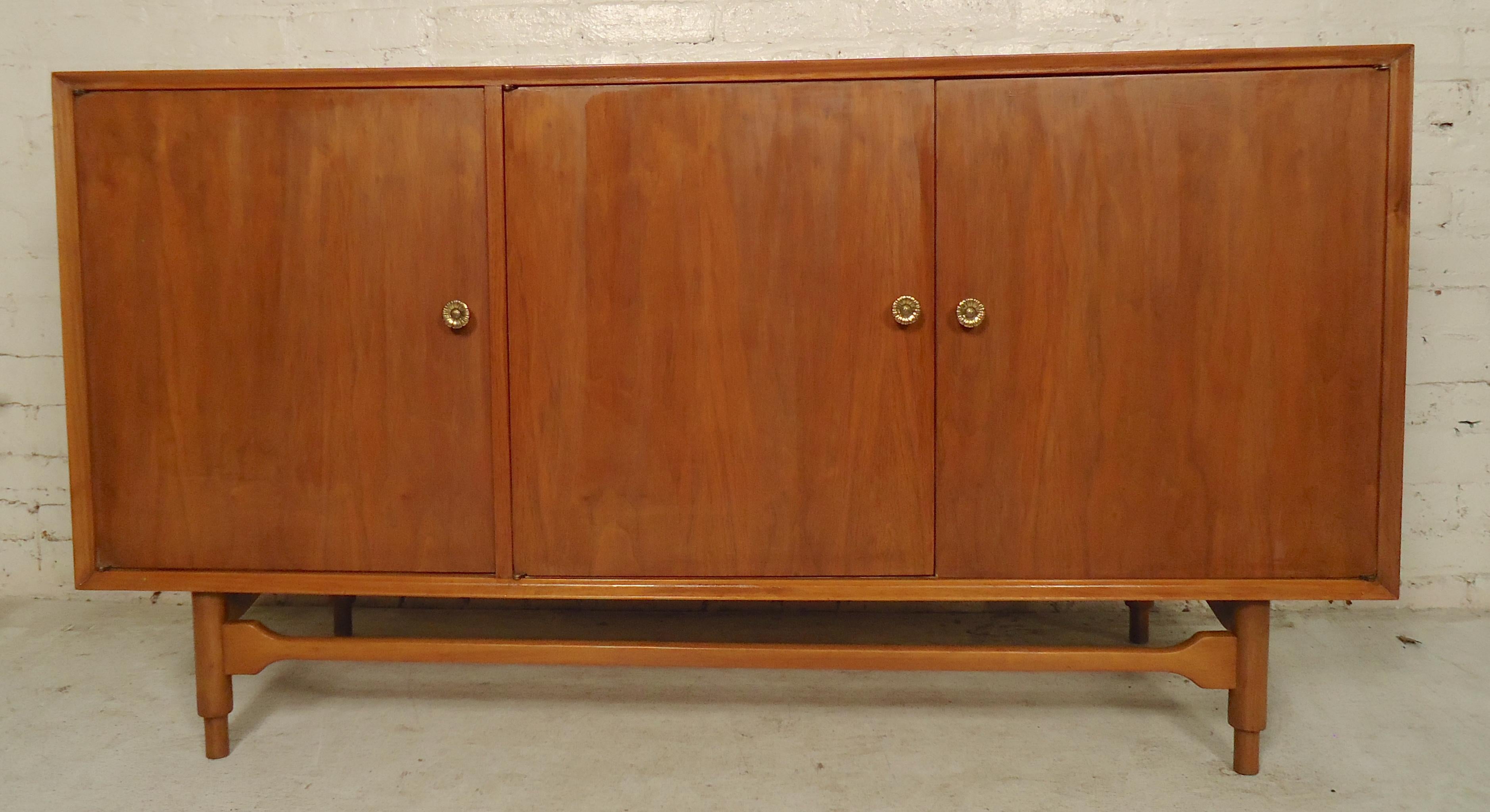 Vintage modern long dresser with three concealing doors. Unique floral brass pulls, six pullout / pull-out drawers.
(Please confirm item location - NY or NJ - with dealer).
  