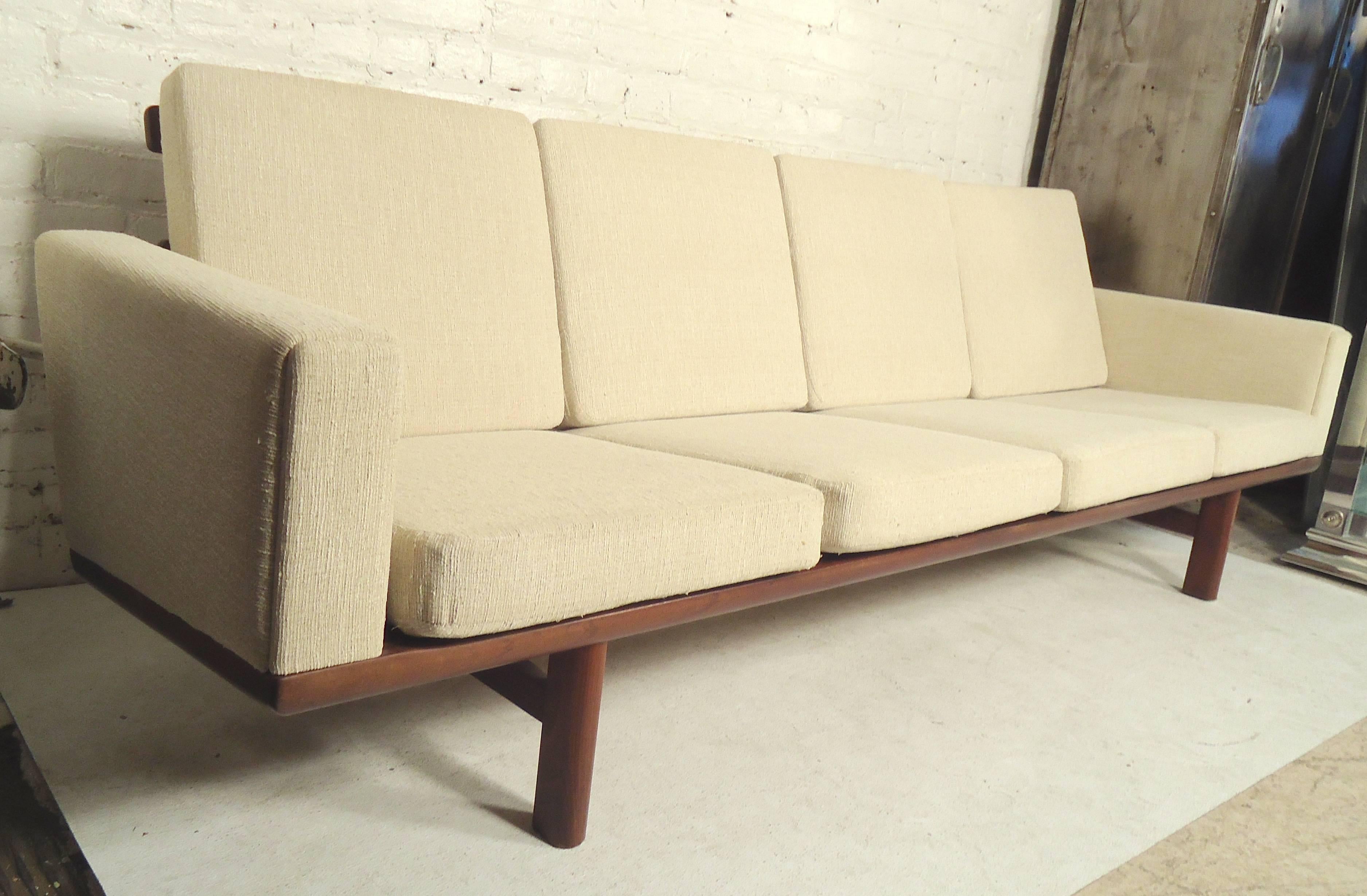 Beautiful four seat sofa by Hans Wegner for GETAMA. Clean fabric on a dark walnut frame. Great design with clean modern lines.

(Please confirm item location - NY or NJ - with dealer).
 