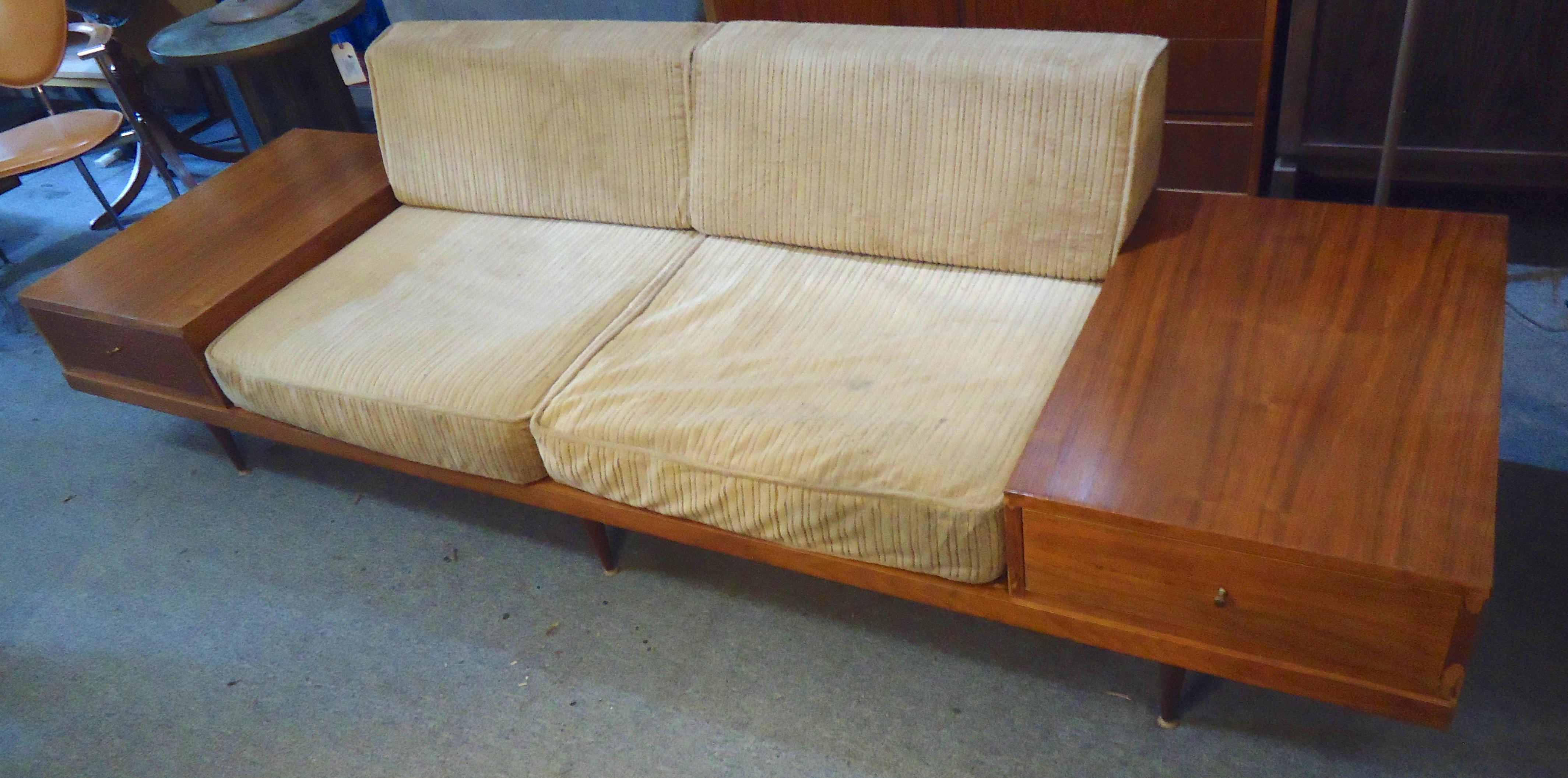 Vintage modern two-seat sofa with built in side tables. Low seating, tapered legs, Paul McCobb style brass handles.

(Please confirm item location - NY or NJ - with dealer).
 