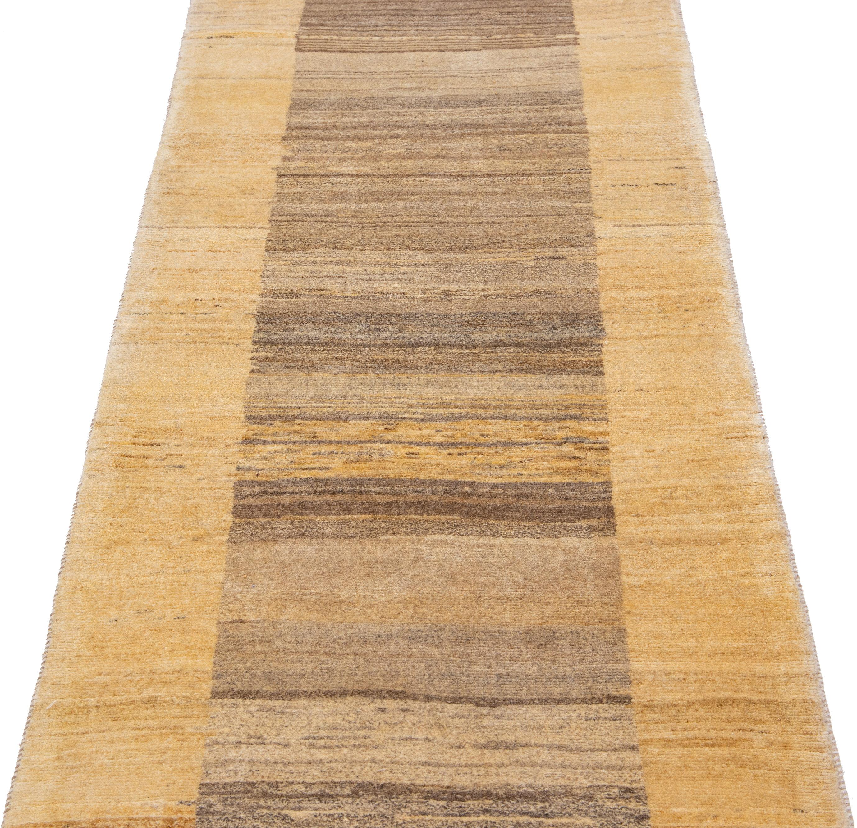 Beautiful modern Gabbeh-style hand-woven wool runner with a brown color field. This piece has beige accents in a gorgeous geometric design.

This rug measures: 2'7