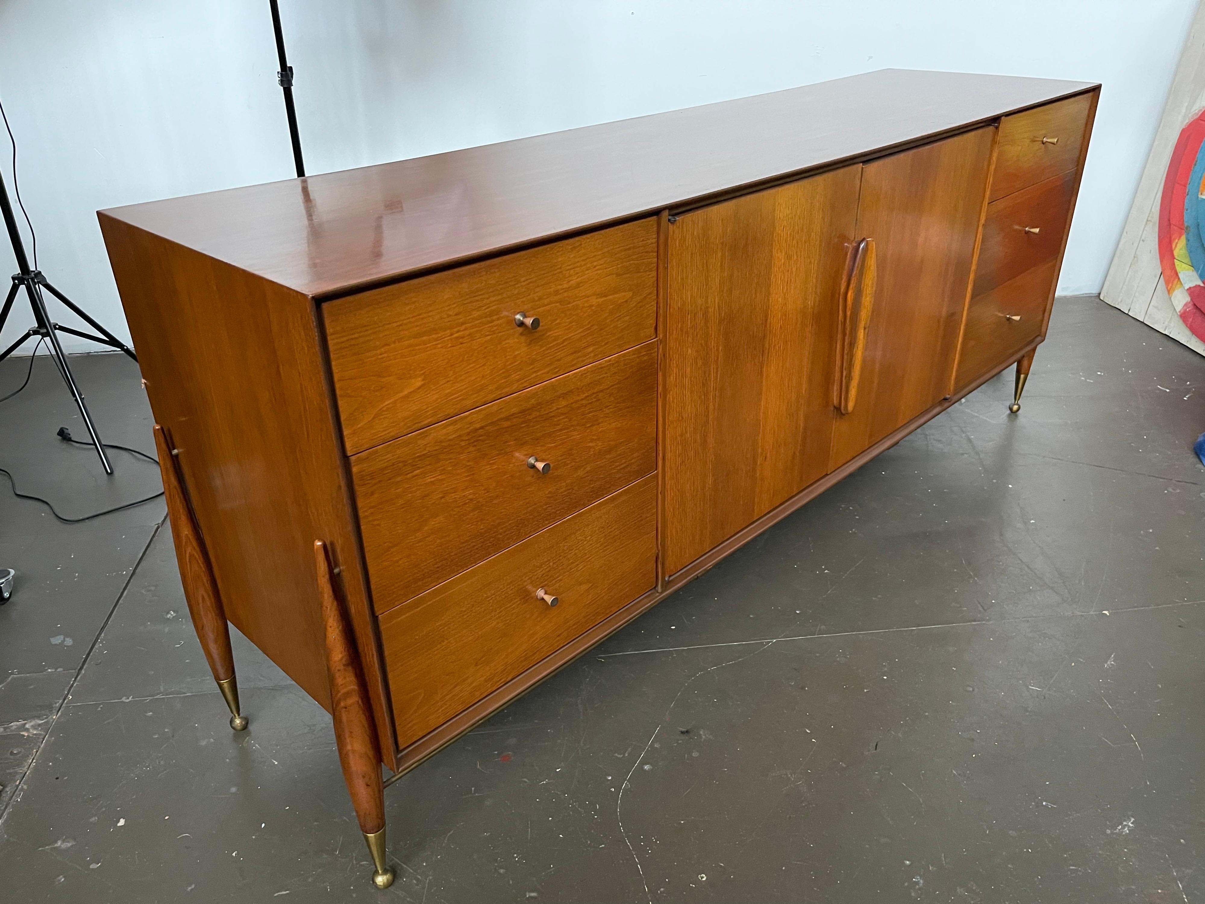 Scarce piece by New Jersey custom furniture makers - Specialty Woodcraft, purchased by the original owner in 1957. The couple didn't have children and it shows in this piece. This long dresser is in original condition with minor spots of wear.