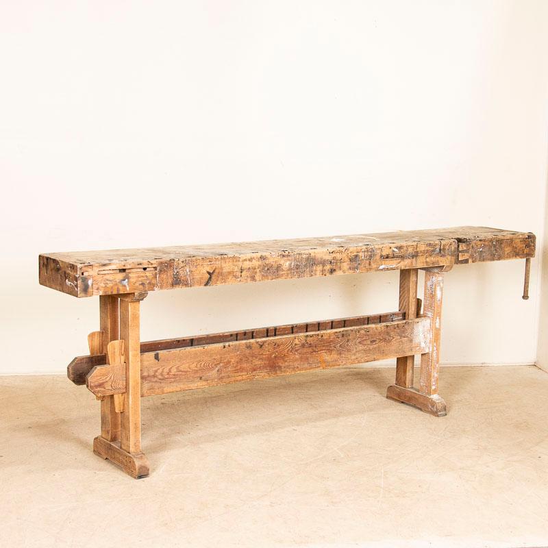 This wonderful old workbench is worn and weathered due to generations of use. Unique to this work table is how long and narrow it is, At over 8' long it can serve as a rustic console table for today's modern home. Notice the wood has an organic,