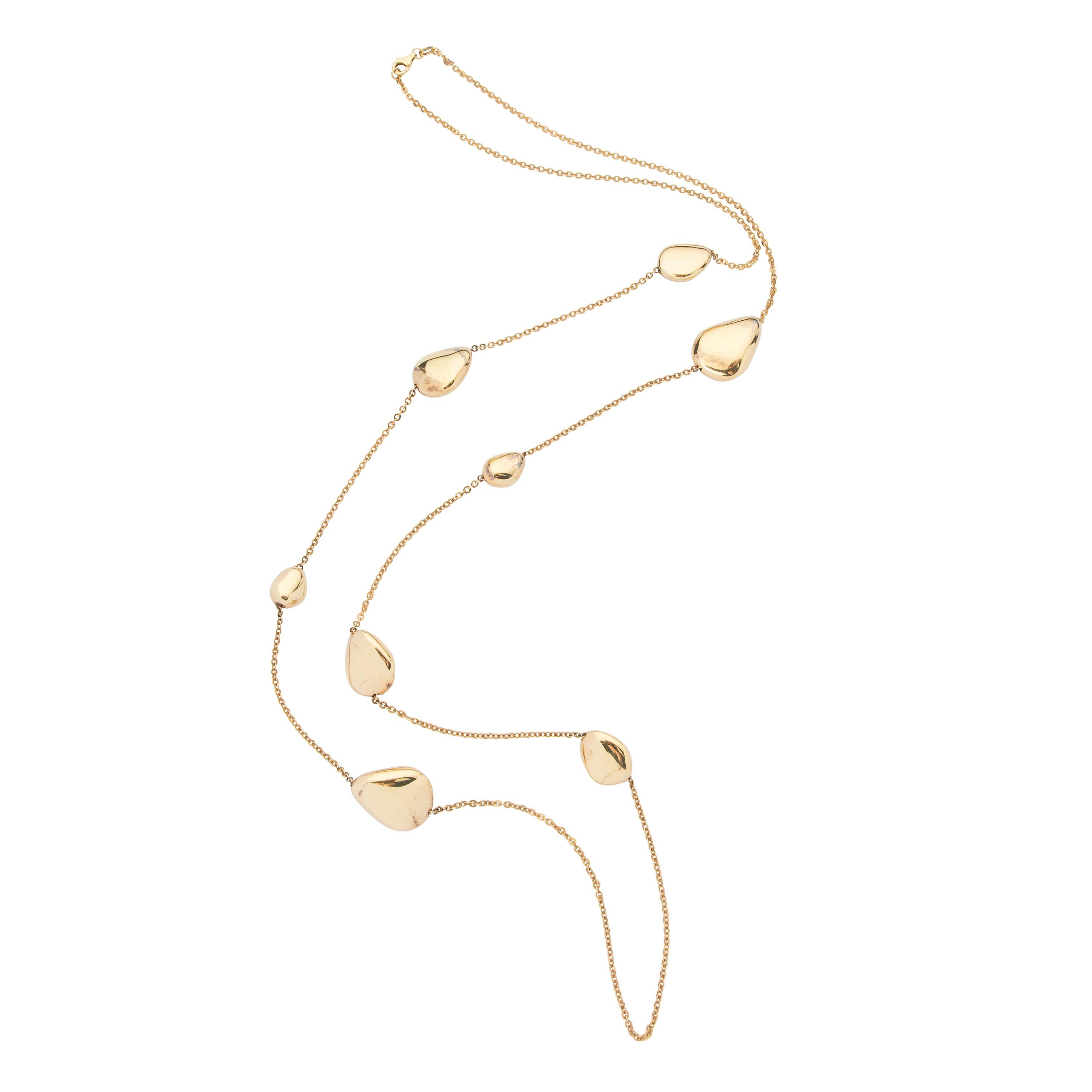 18 karat yellow gold long necklace featuring 8 gold nuggets.