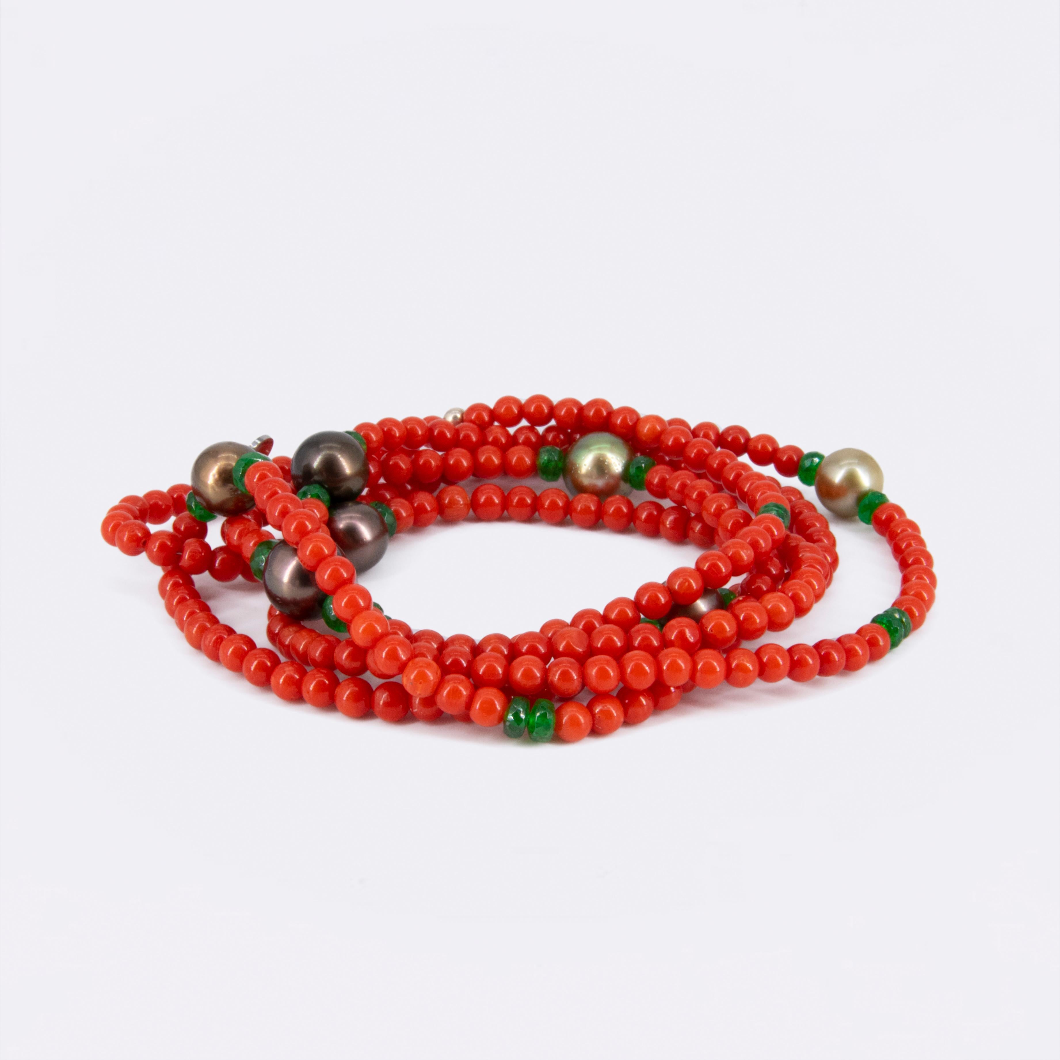 Mediterranen coral (naturally red, not dyed) and pearls do belong together. In this necklace,  AAA Tahitian pearls in a blue and greenish shimmer have been used to give the 4 mm coral beads the habitat of the sea. The toxic green tsavorites