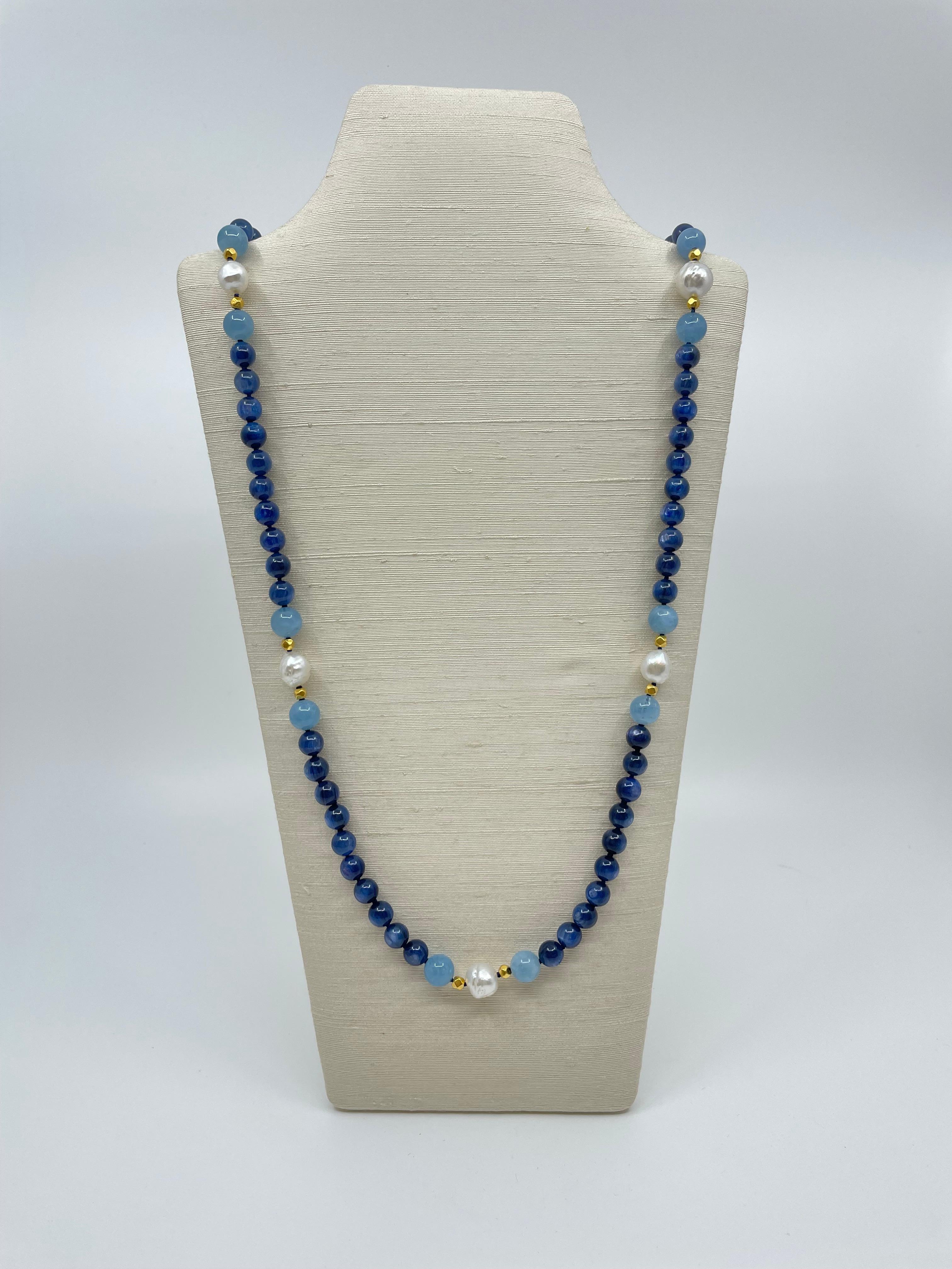 From our Amalfi collection, the fabulous necklace is handcrafted with vibrant blue kyanite beads, interspaced with six groups of soft blue aquamarine beads and solid 18K gold beads with South Sea pearl in the middle, and aquamarine beads at the ends