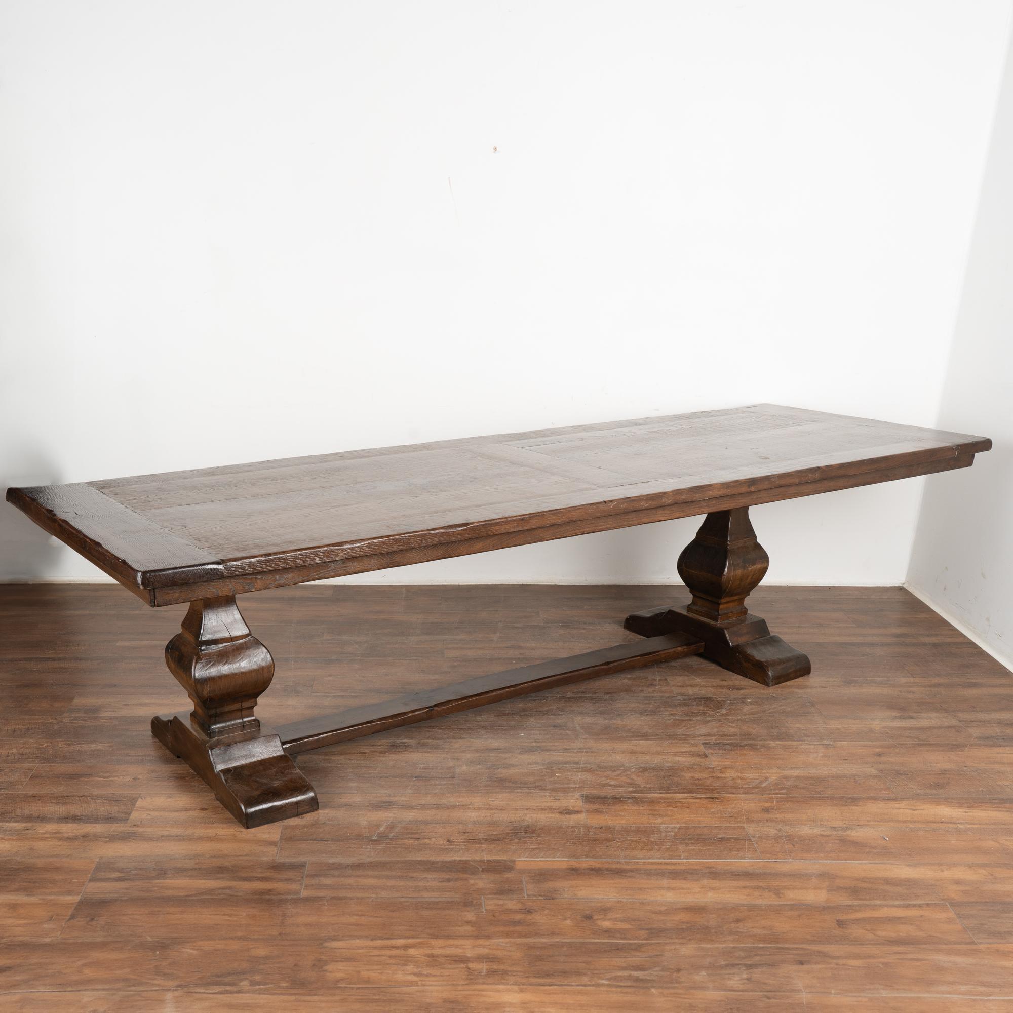 Striking in size at just under 10' long, this dramatic dining table will make a grand gathering place in today's modern home.
The heavy oak top is impressive; rich character is revealed in the scratches, nicks, and distress which create the appeal
