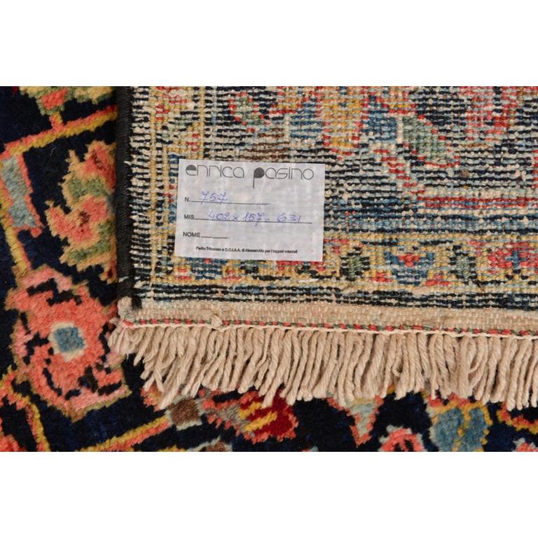 Wonderful old Armenian long carpet, with pastel colors on a dark blue, with a classic design. 
Set in a modern house, it distorts its whole aspect: decidedly unusual.